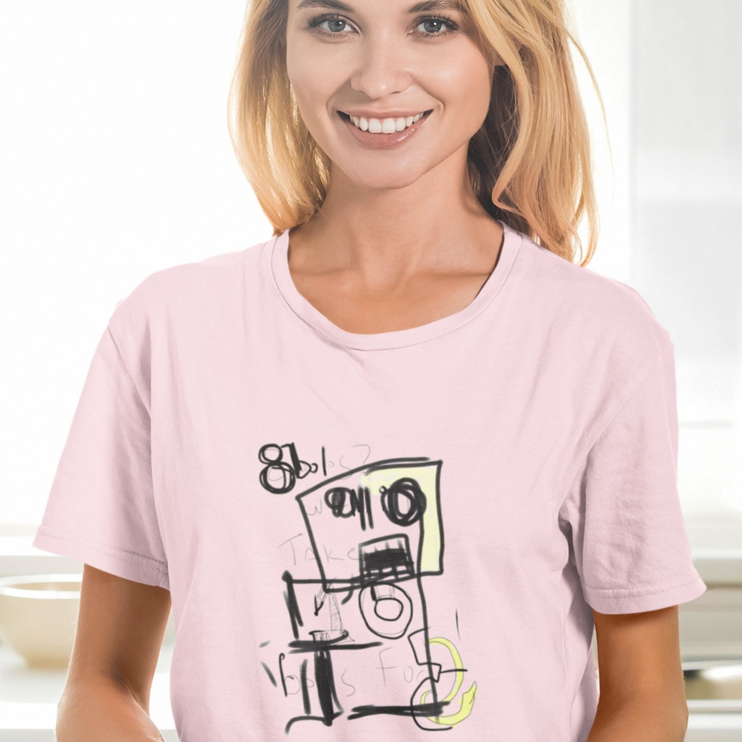 Woman wearing a pink t-shirt with a graphic design on a white background.