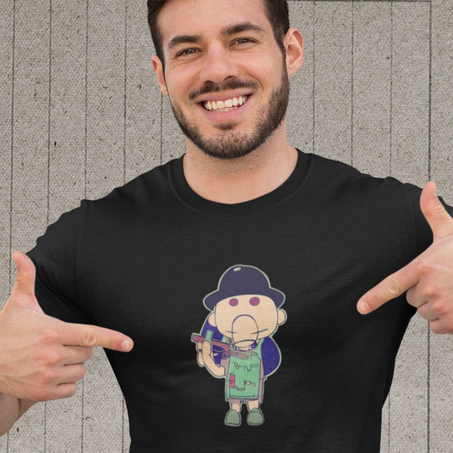Happy man wearing a black t-shirt with a fun, colorful cartoon illustration on a grey background.