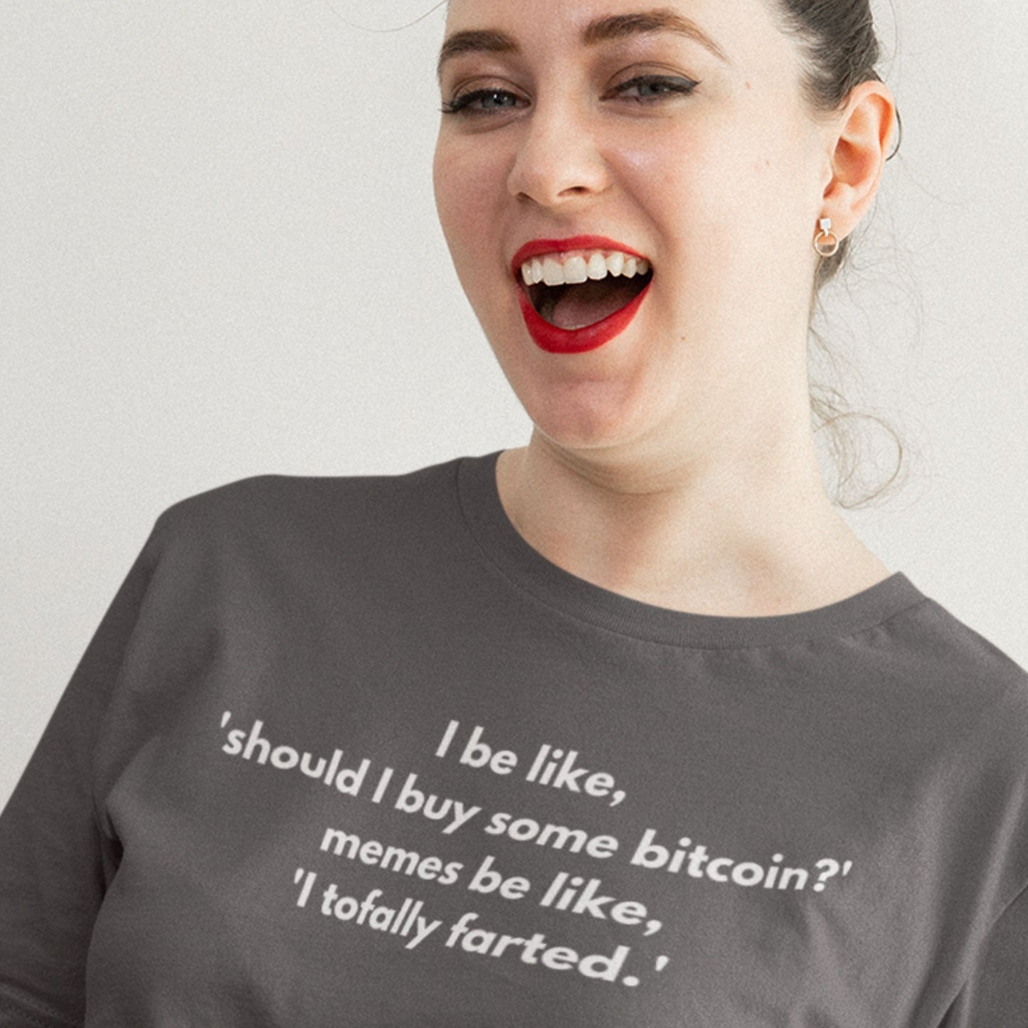 Woman wearing a gray t-shirt with humorous text design.