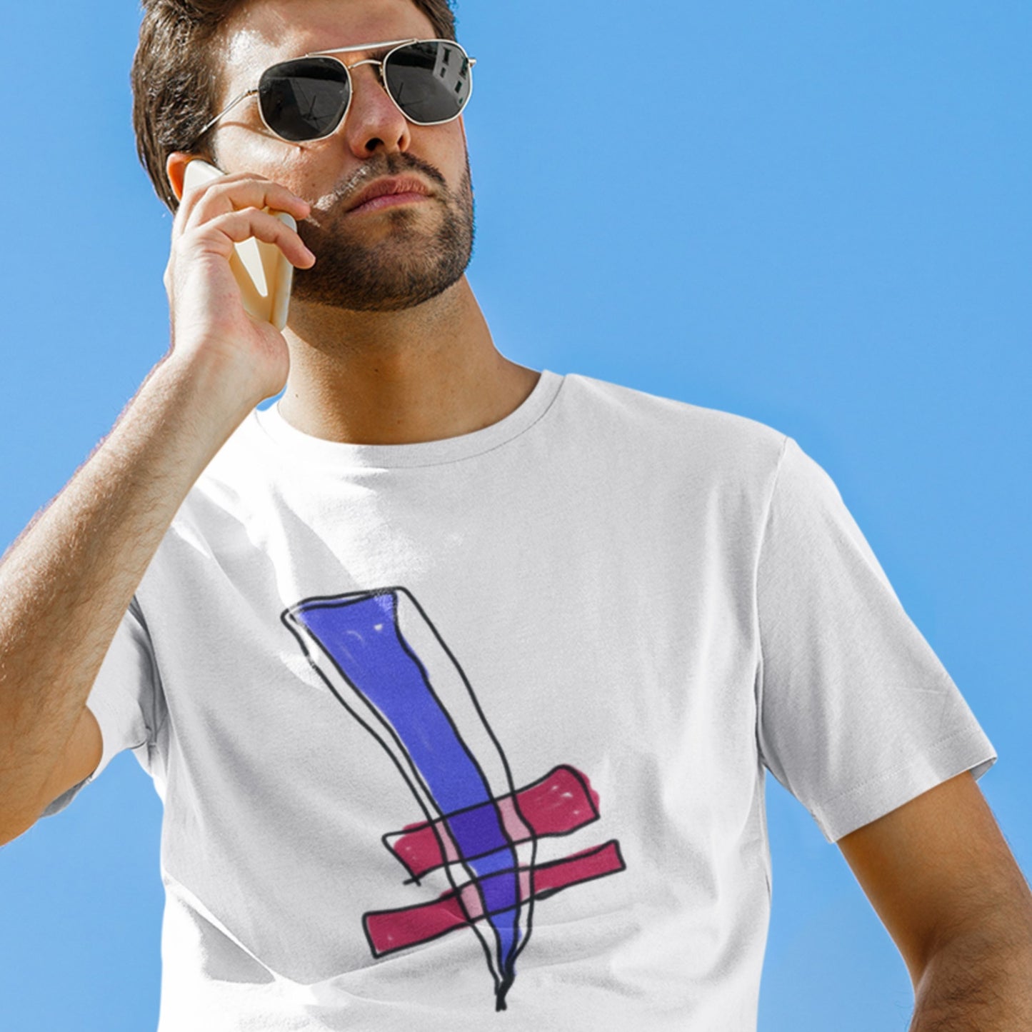 Man wearing a white t-shirt with a colorful abstract design against a clear blue sky.