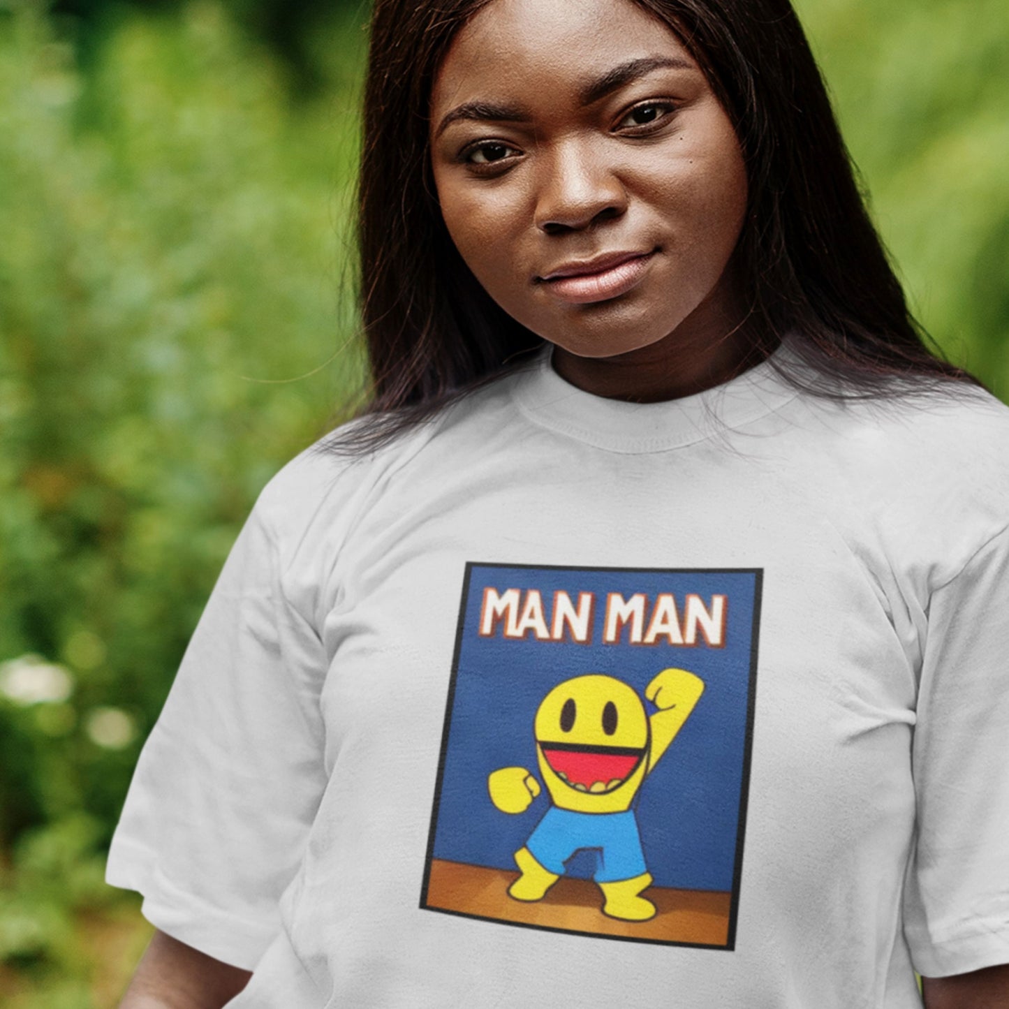 Person wearing a t-shirt with a cartoon character and 'MAN MAN' text.