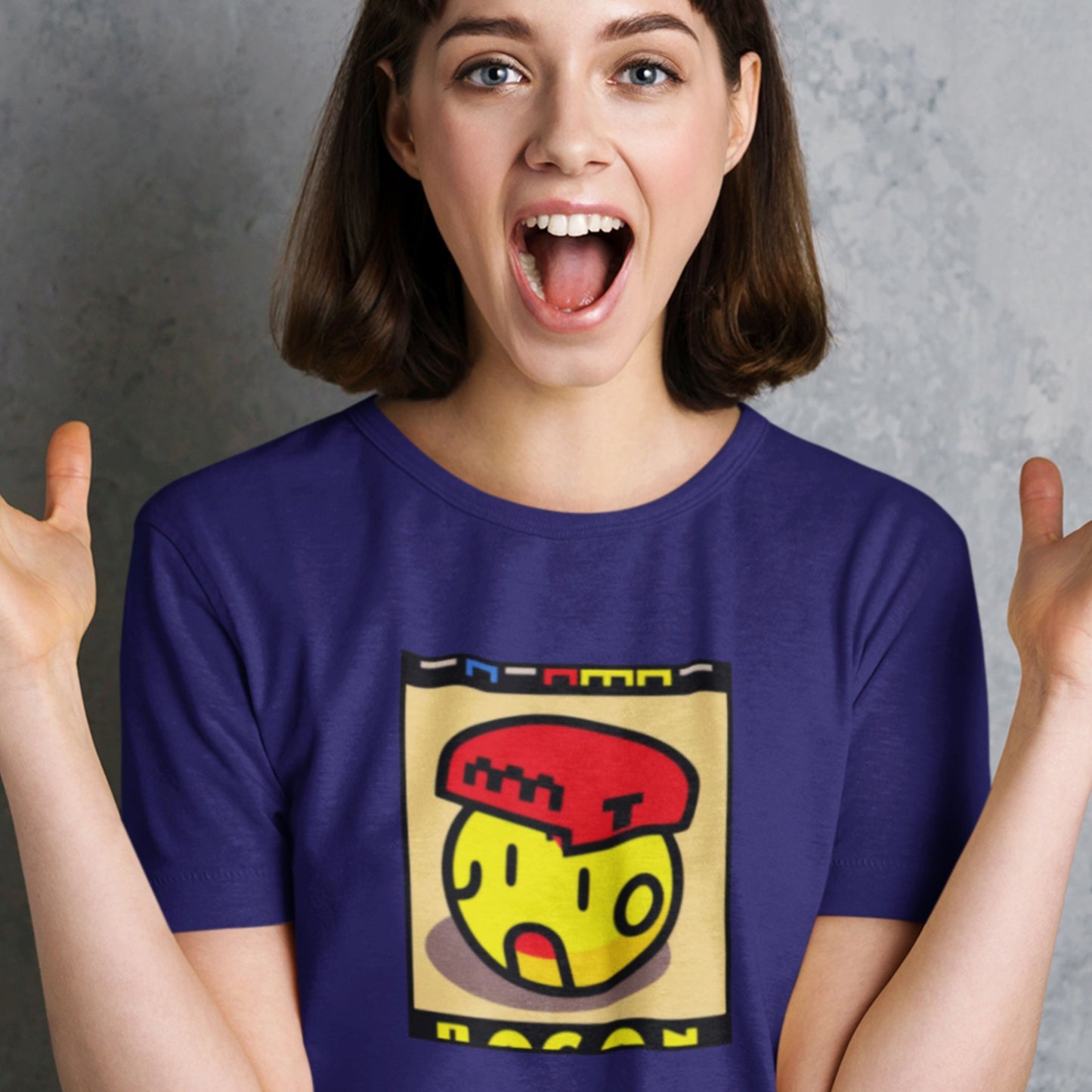 Person wearing a purple t-shirt with a colorful graphic design on a gray background.