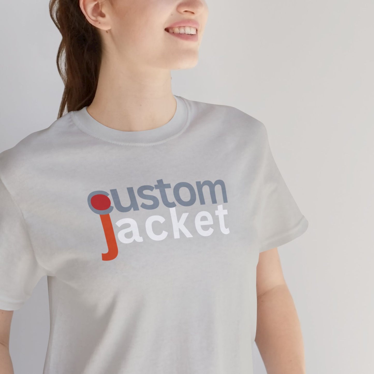 Person wearing a white t-shirt with 'custom jacket' printed on it against a plain background.