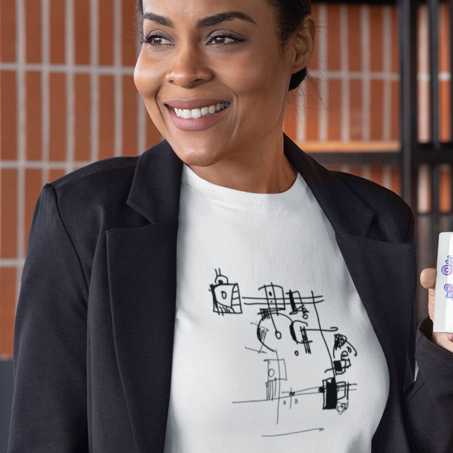 Woman wearing a white Grey t-shirt with an abstract line drawing in an office.