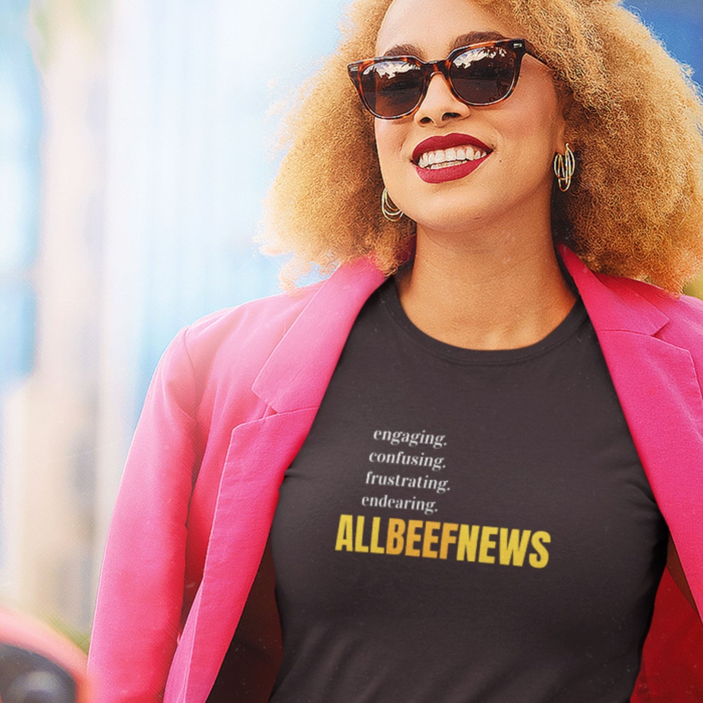 Happy woman wearing a black t-shirt with humorous nonsensical colorful text outdoors.