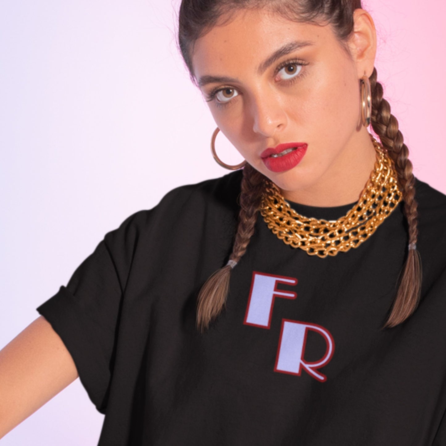 Woman wearing a black t-shirt with 'FR' on a pink background
