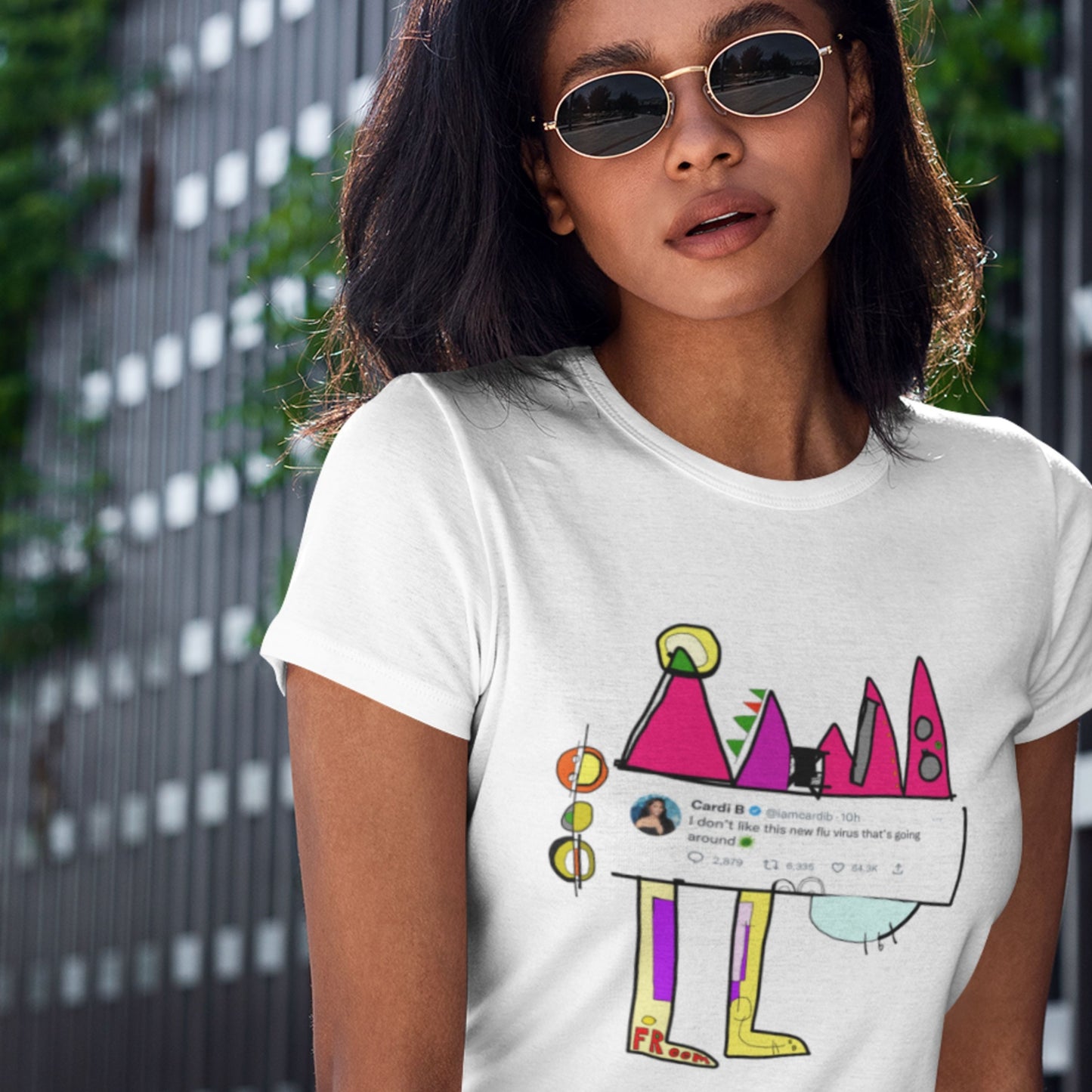 Person wearing a white t-shirt with a colorful graphic design.