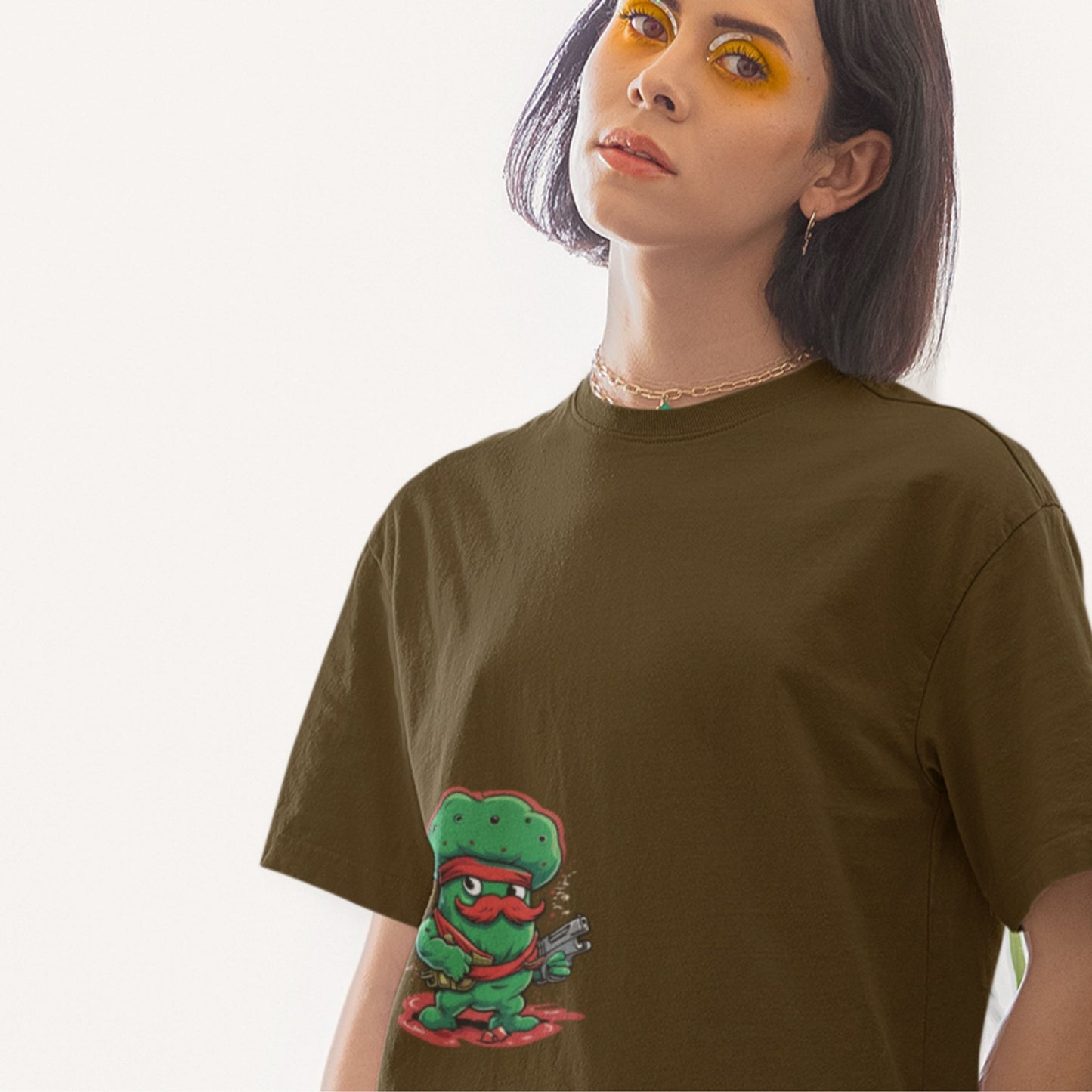 Person wearing a green t-shirt with a graphic design on a plain background