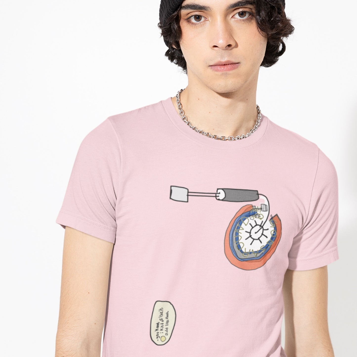 Person wearing a pink t-shirt with a graphic design on a white background.