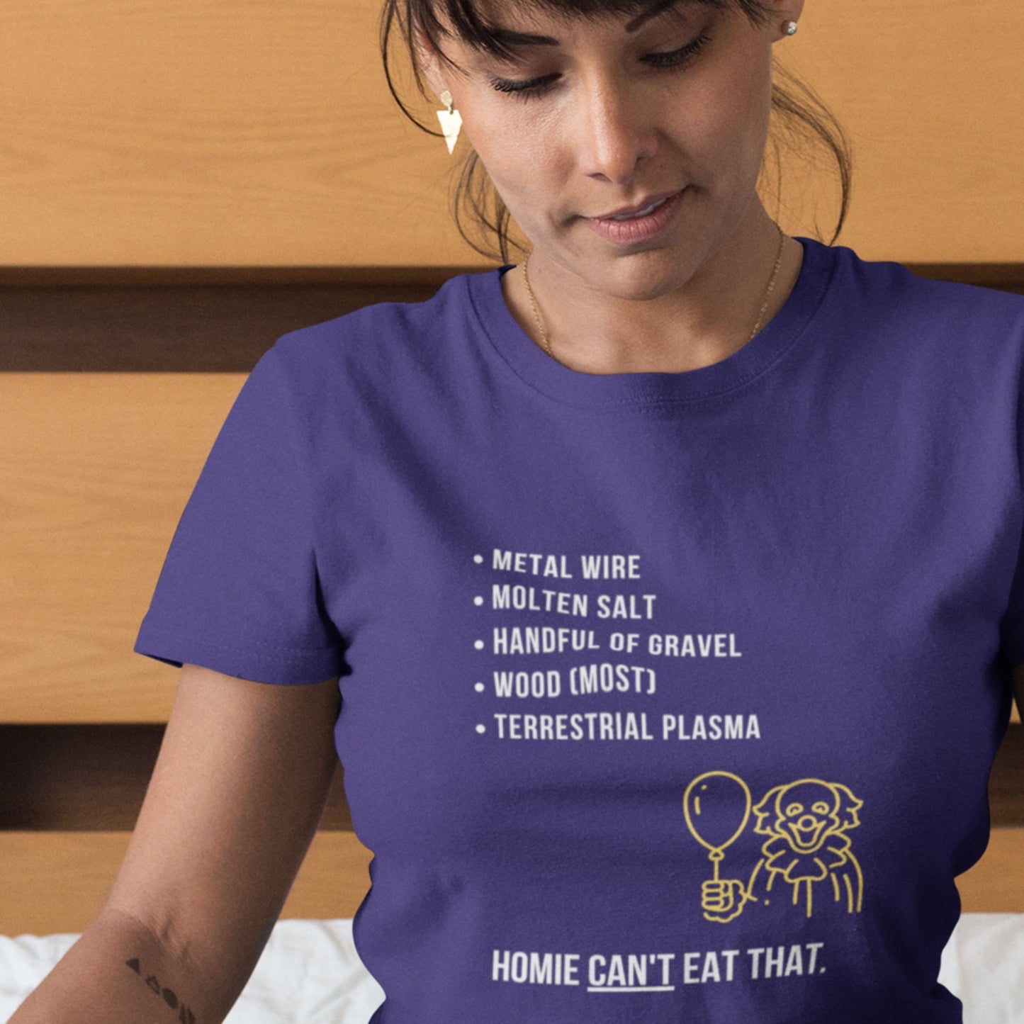 Person wearing a navy blue t-shirt with a humorous graphic and text.