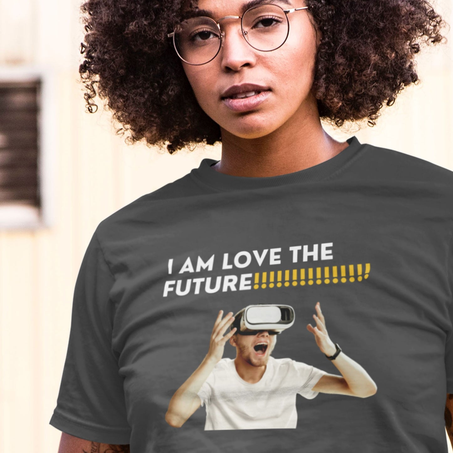 Person wearing a t-shirt with a graphic and text 'I AM LOVE THE FUTURE' and an image of a person using VR goggles.
