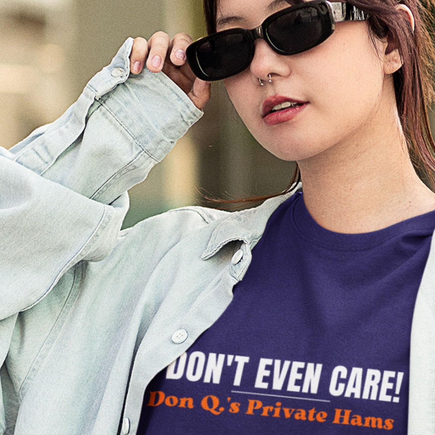 Person wearing a shirt with text 'I DON'T EVEN CARE! Don Q's Private Hams' outdoors.