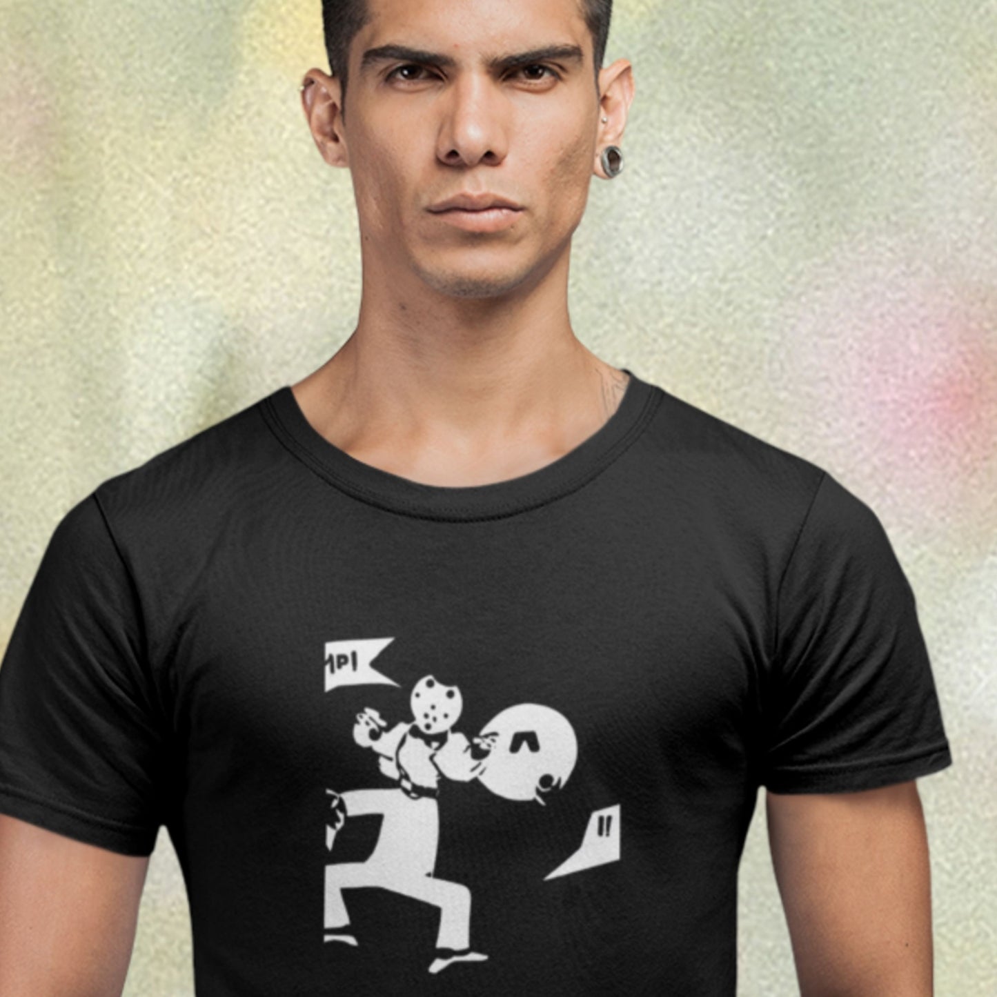 Man wearing a black t-shirt with a graphic design on a textured background