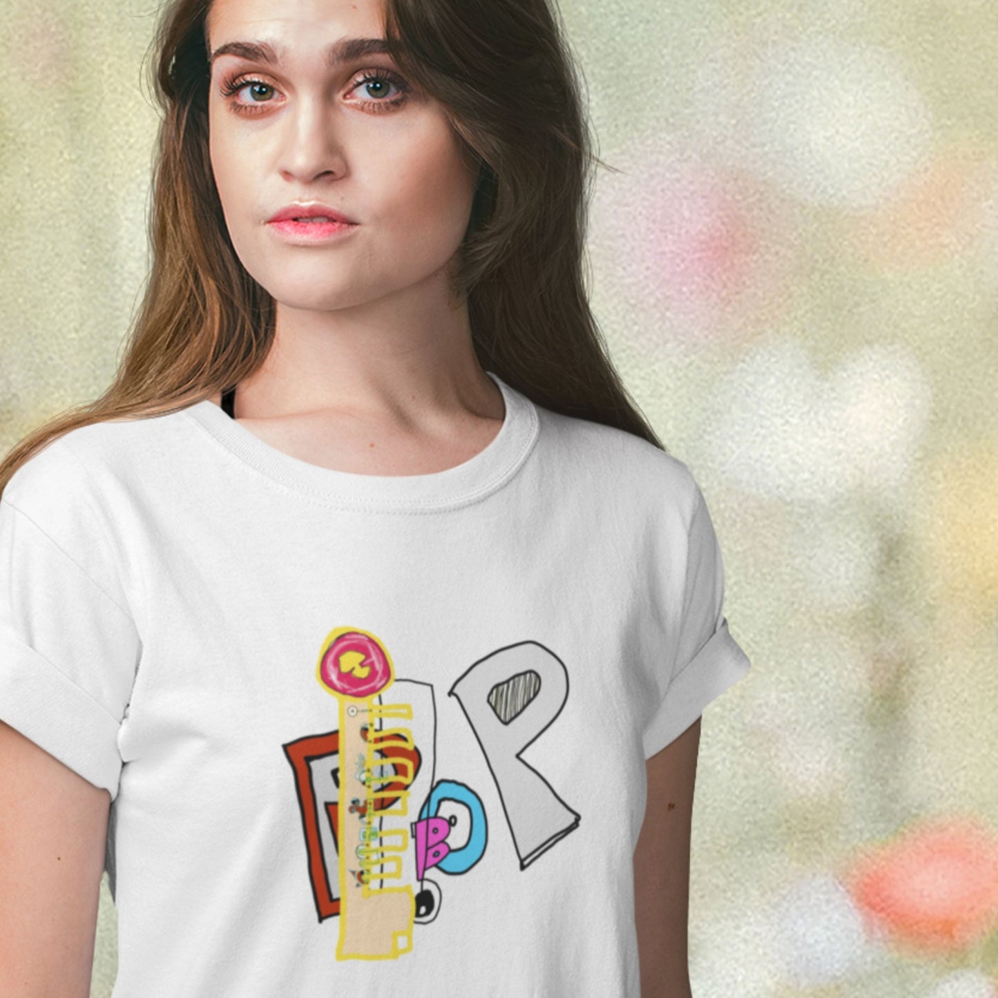 Person wearing a white t-shirt with colorful graphic design on a blurred background