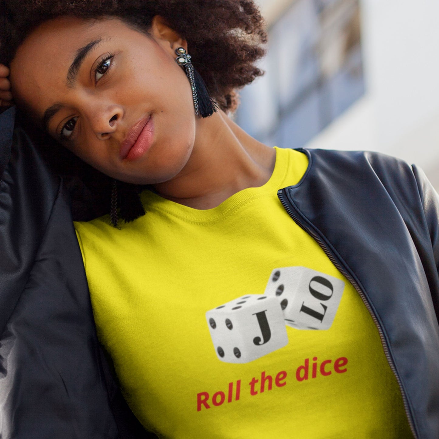Person wearing a yellow shirt with dice graphics and text.
