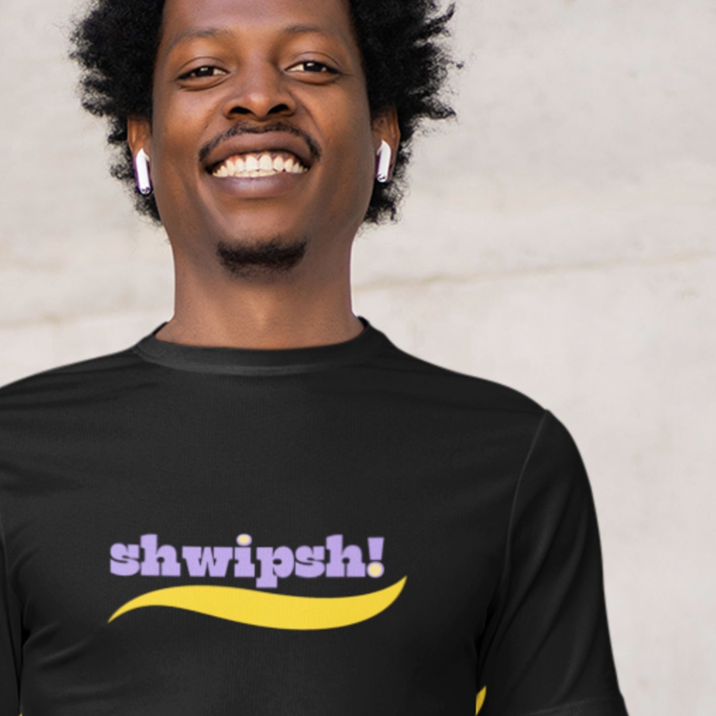 Person wearing a black t-shirt with 'shwipsh!' text and design.