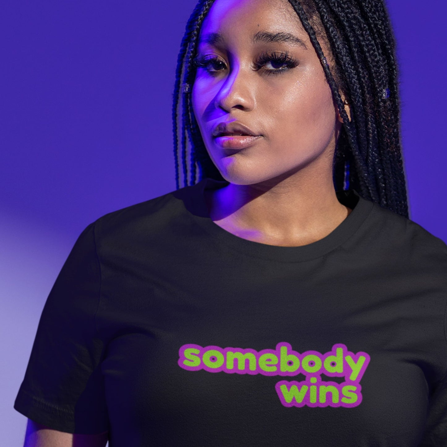 Serious woman wearing a black t-shirt with multicolored 'somebody wins' text on a purple umbre background.