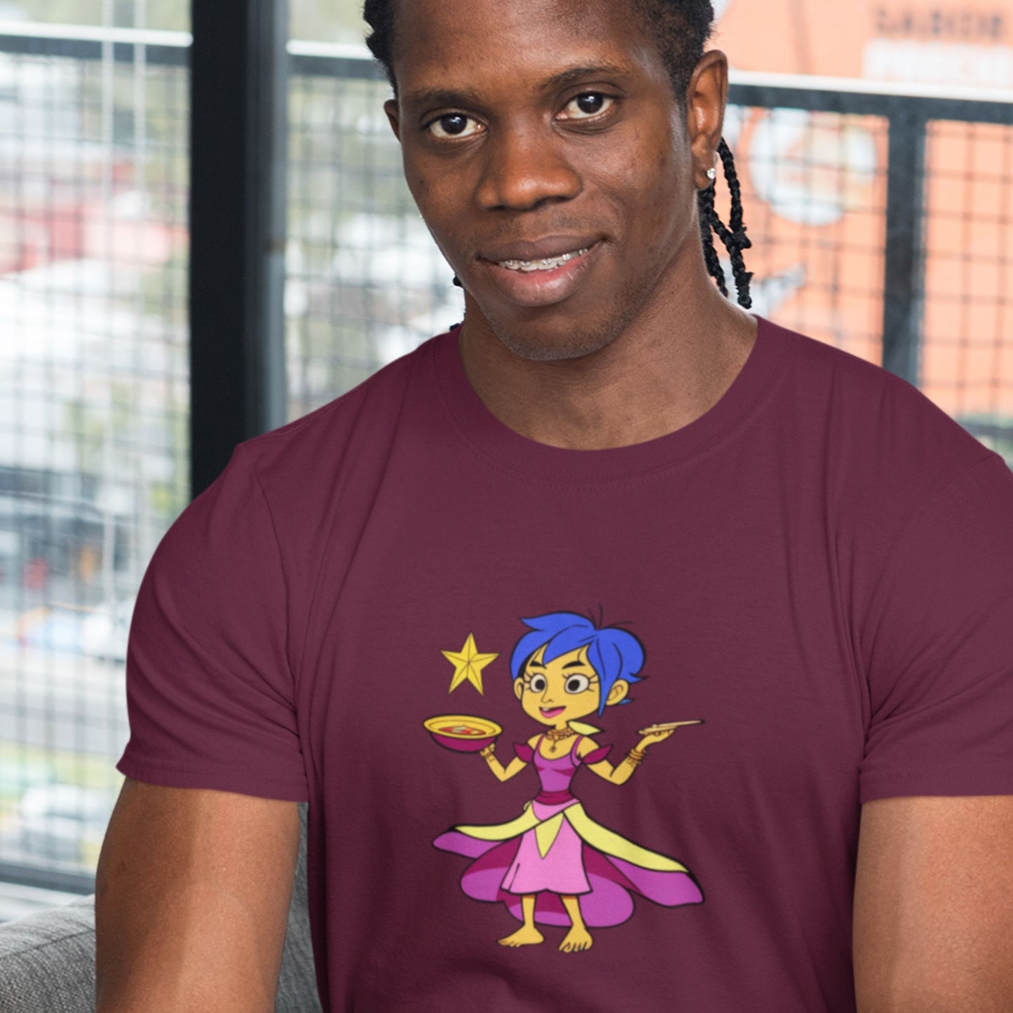 Man wearing a maroon t-shirt with a fun, colorful cartoon server illustration in a gym.