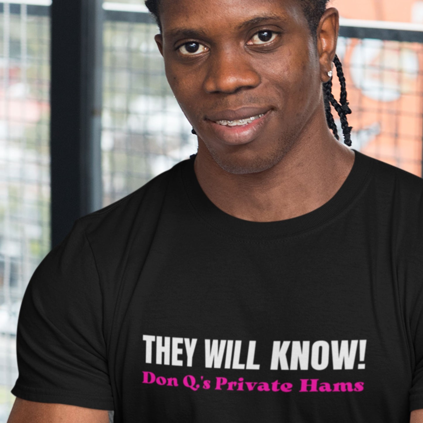 Person wearing a black t-shirt with text in a casual setting.