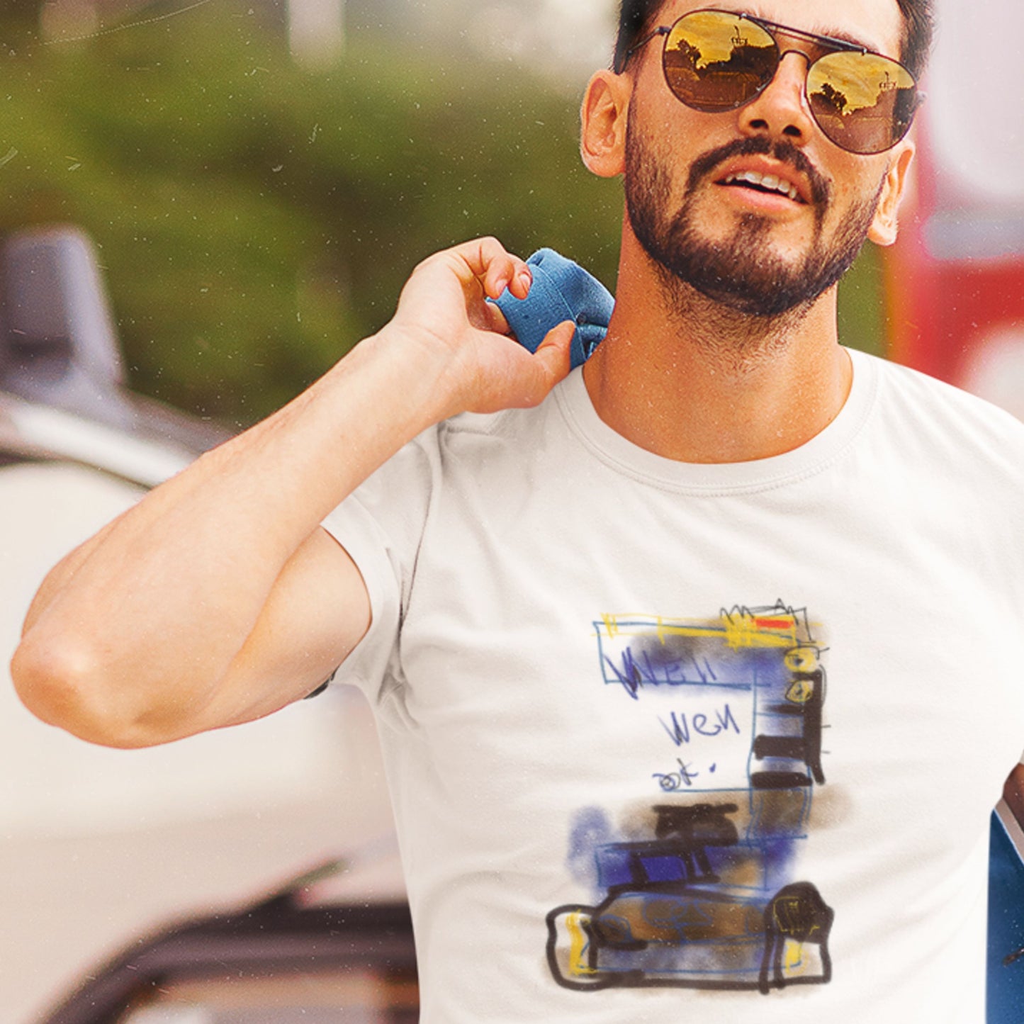 Man wearing a white t-shirt with a graphic design, holding a blue object.