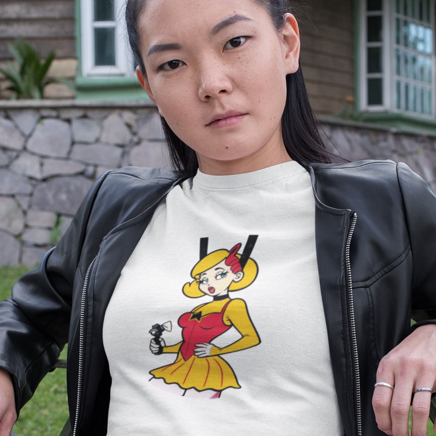 Attitude woman wearing a white t-shirt with a fun, colorful cartoon illustration in front of your house.