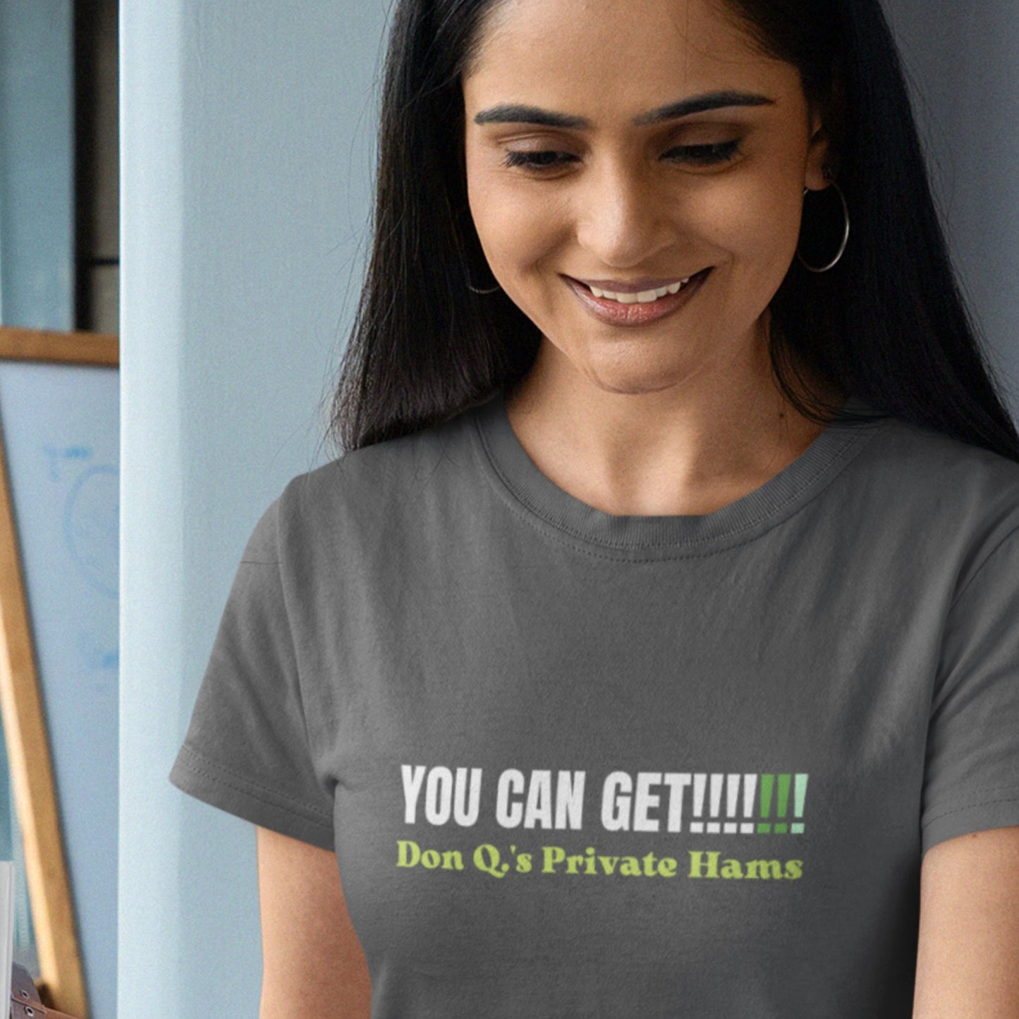 Woman wearing a gray t-shirt with humorous text design.