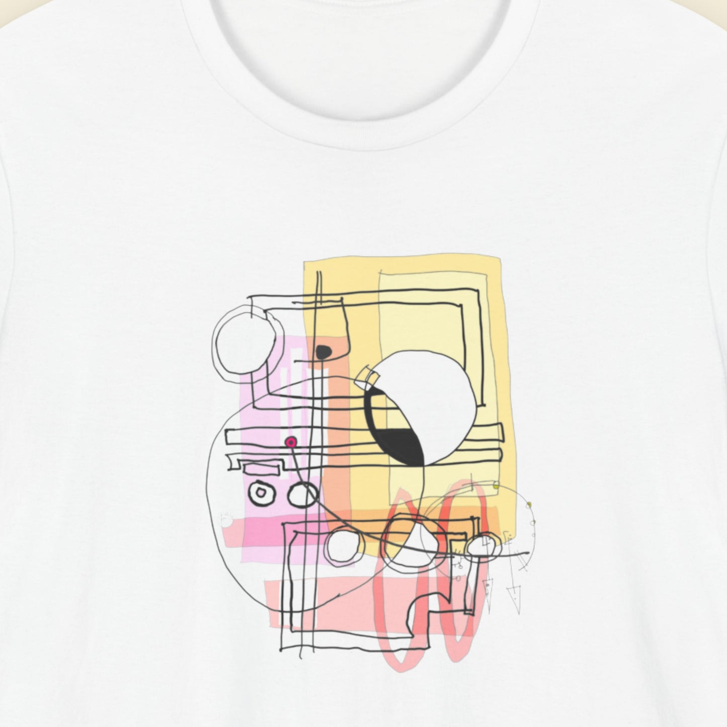 White t-shirt with a colorful abstract system diagram drawing on a beige background.