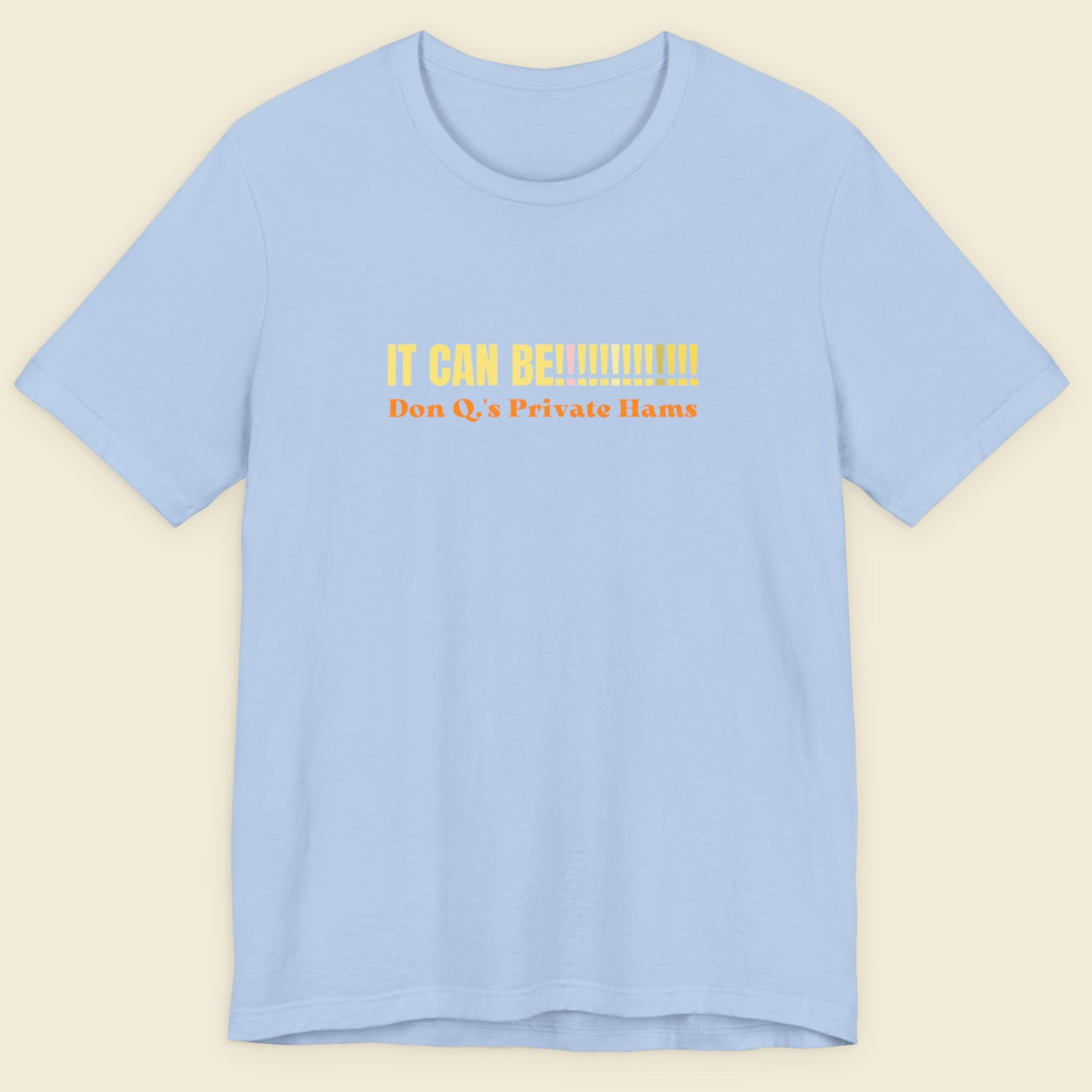 Light blue t-shirt with yellow text on a beige background.
