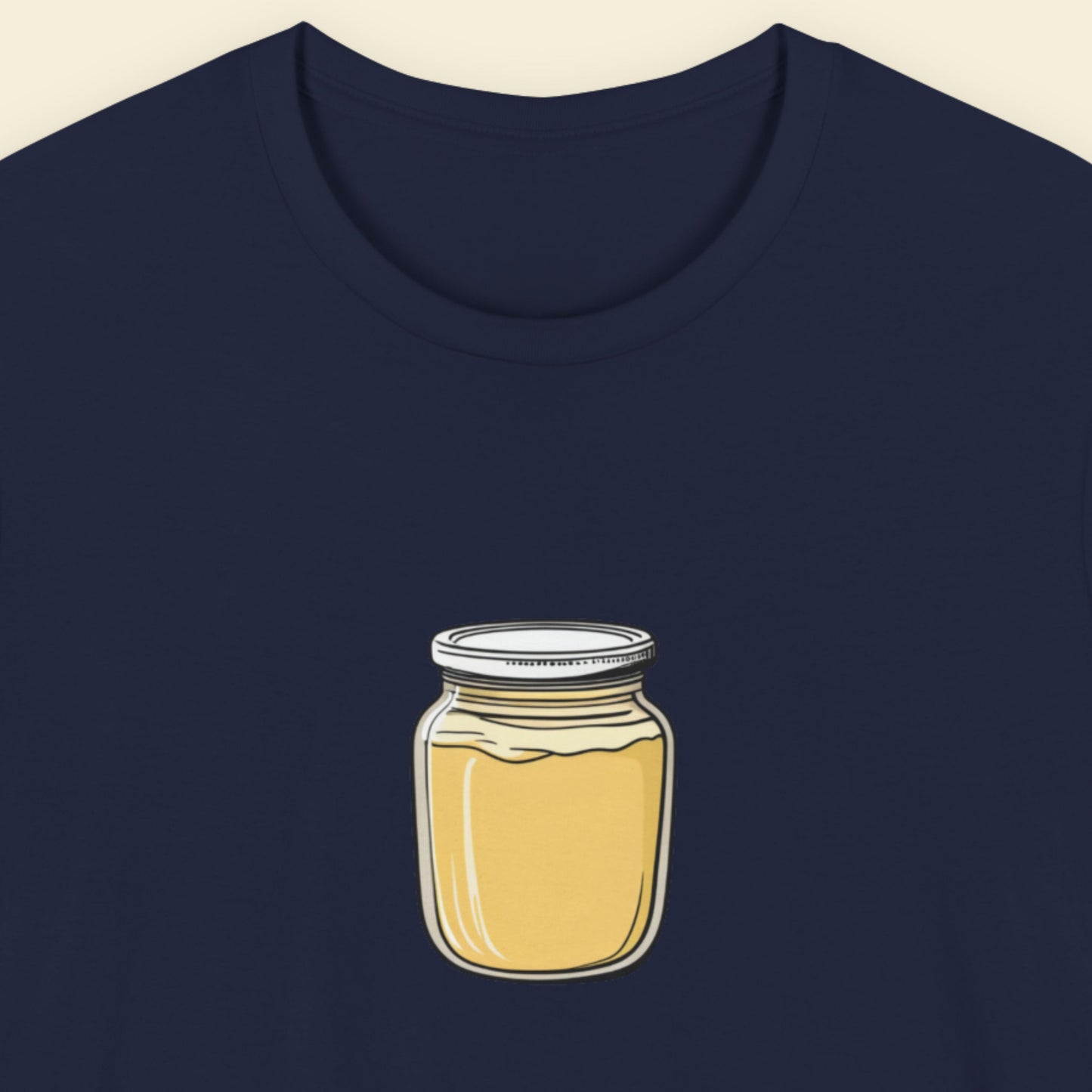 Navy blue t-shirt with an illustration of a jar of dijon on a beige background.