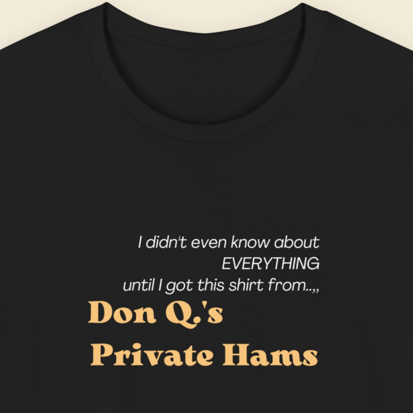 Black t-shirt with humorous text about Don Q's Private Hams on a beige background.