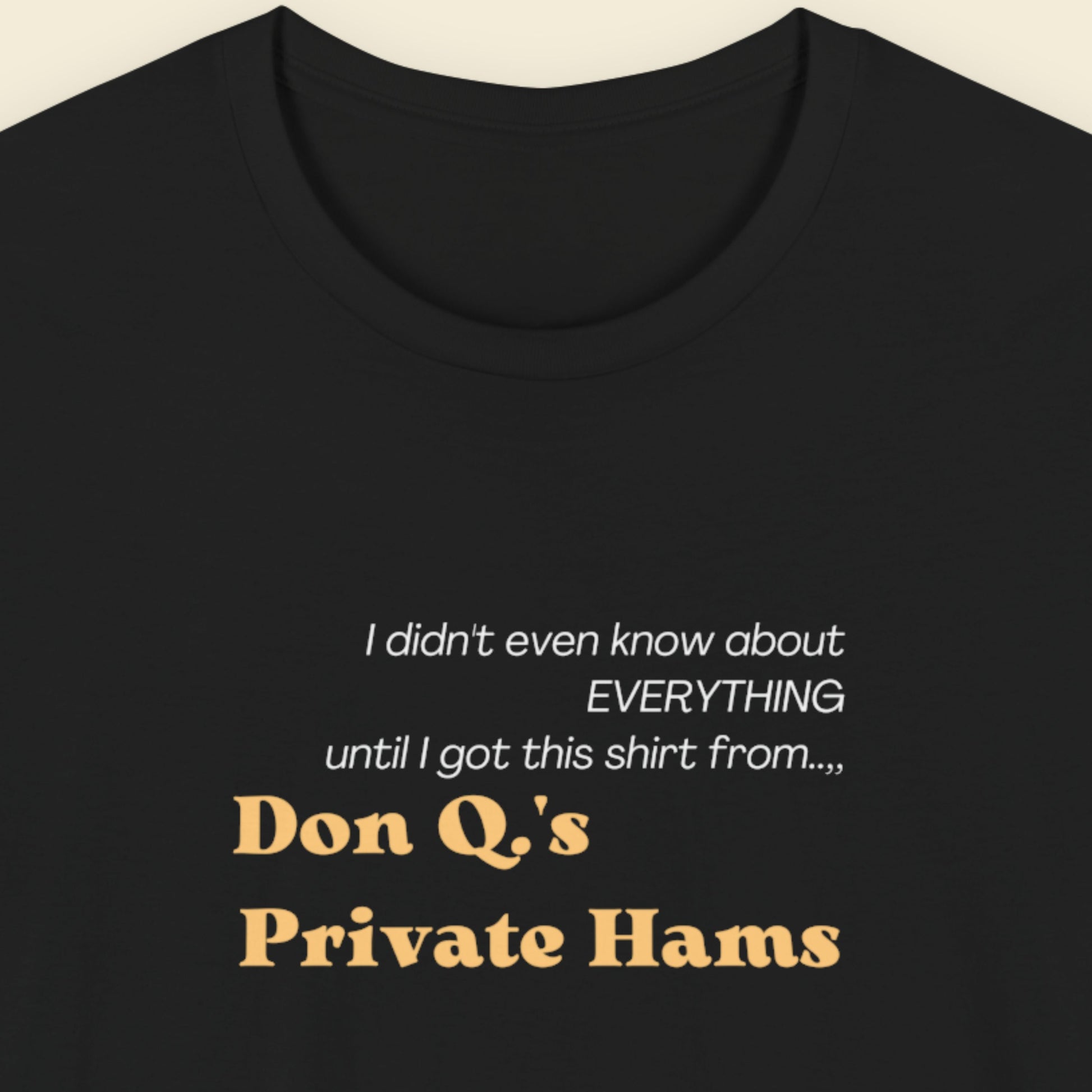 Black t-shirt with humorous text about Don Q's Private Hams on a beige background.