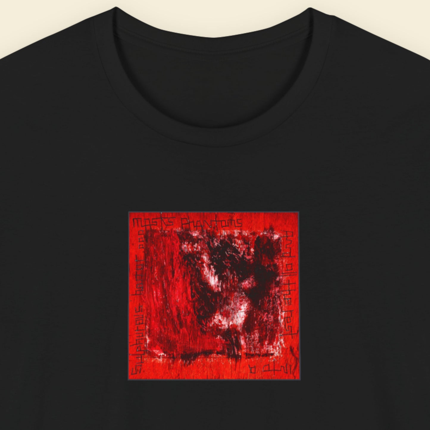 Black t-shirt with a red and black abstract design on a beige background