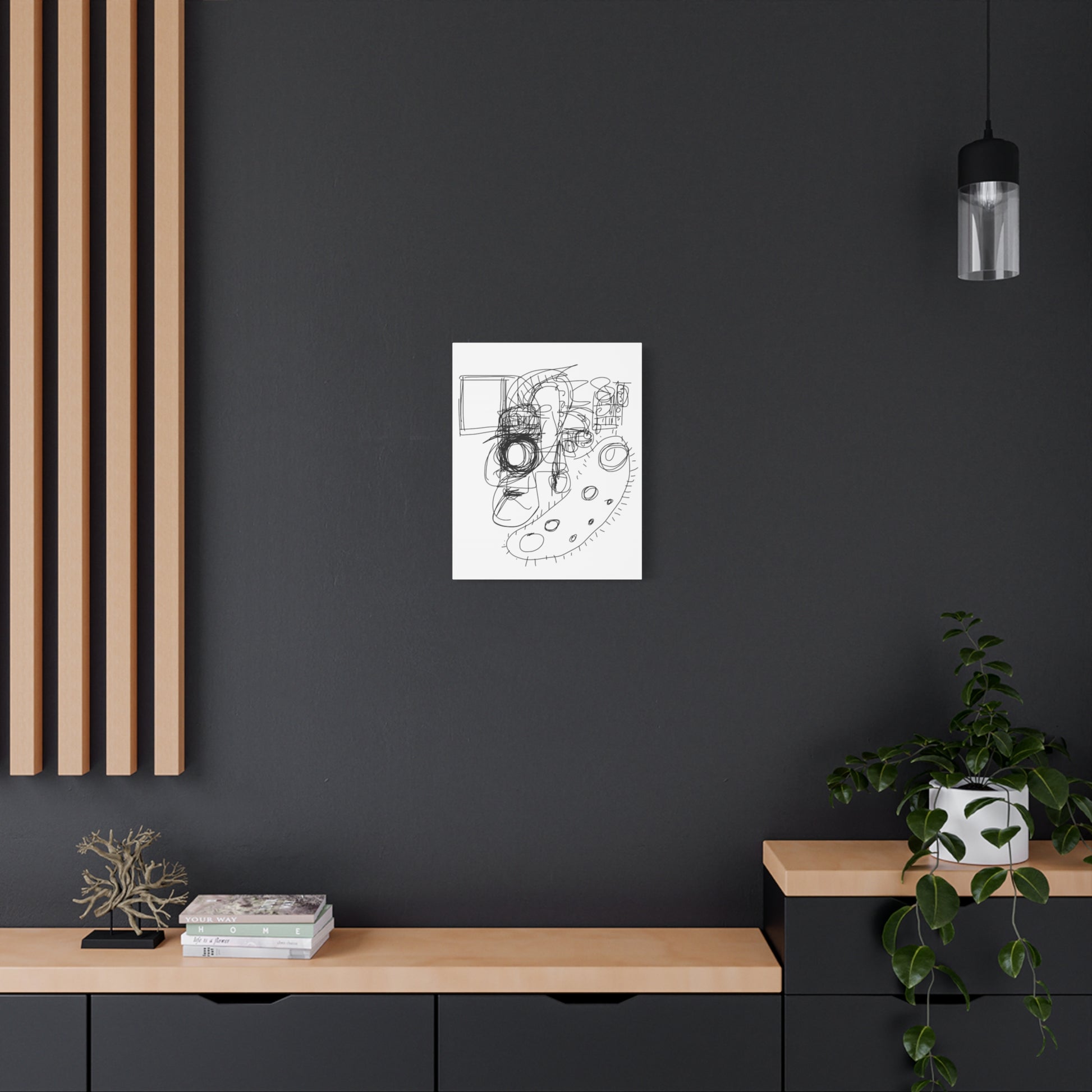 Black line art print on a black wall above a wooden shelf with decor items.