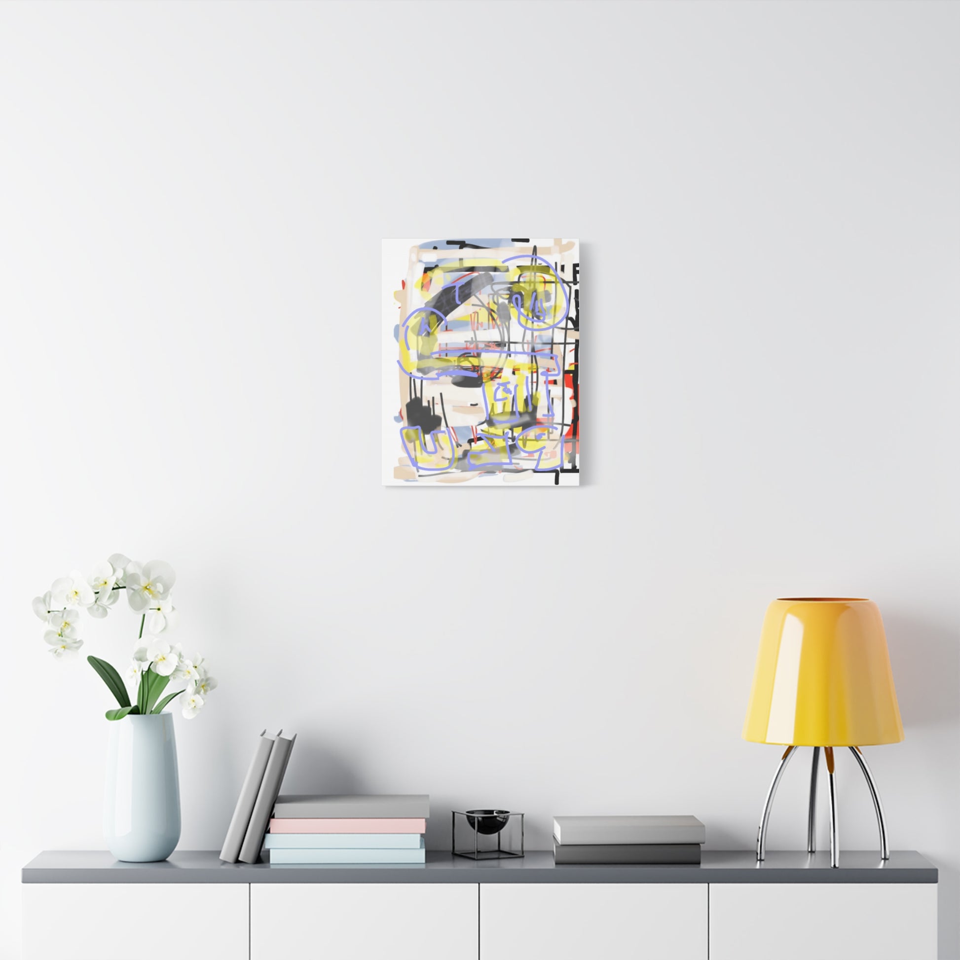 Abstract painting on a wall above a table with decor items