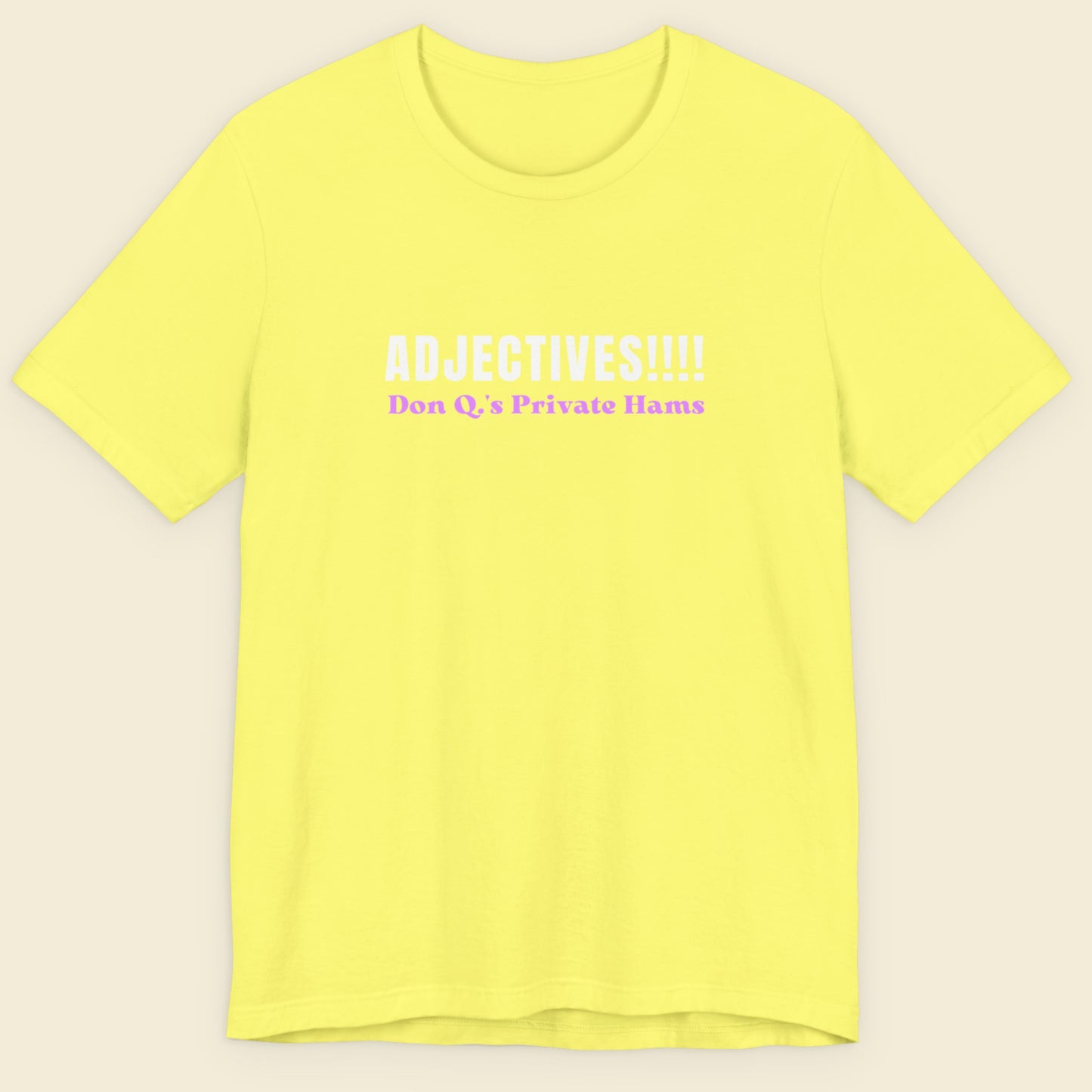 Yellow t-shirt with humorous colorful text on a beige background.