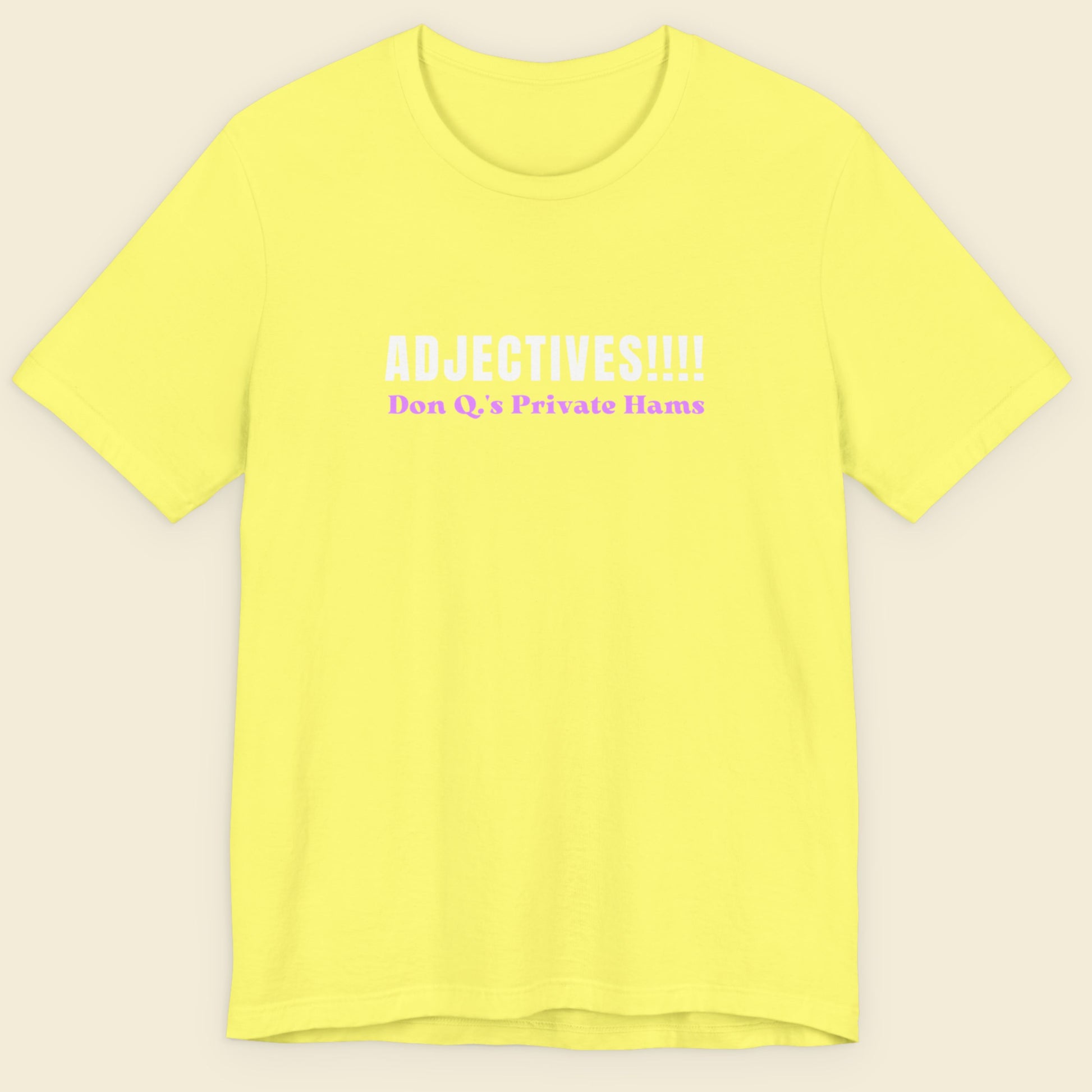 Yellow t-shirt with humorous colorful text on a beige background.