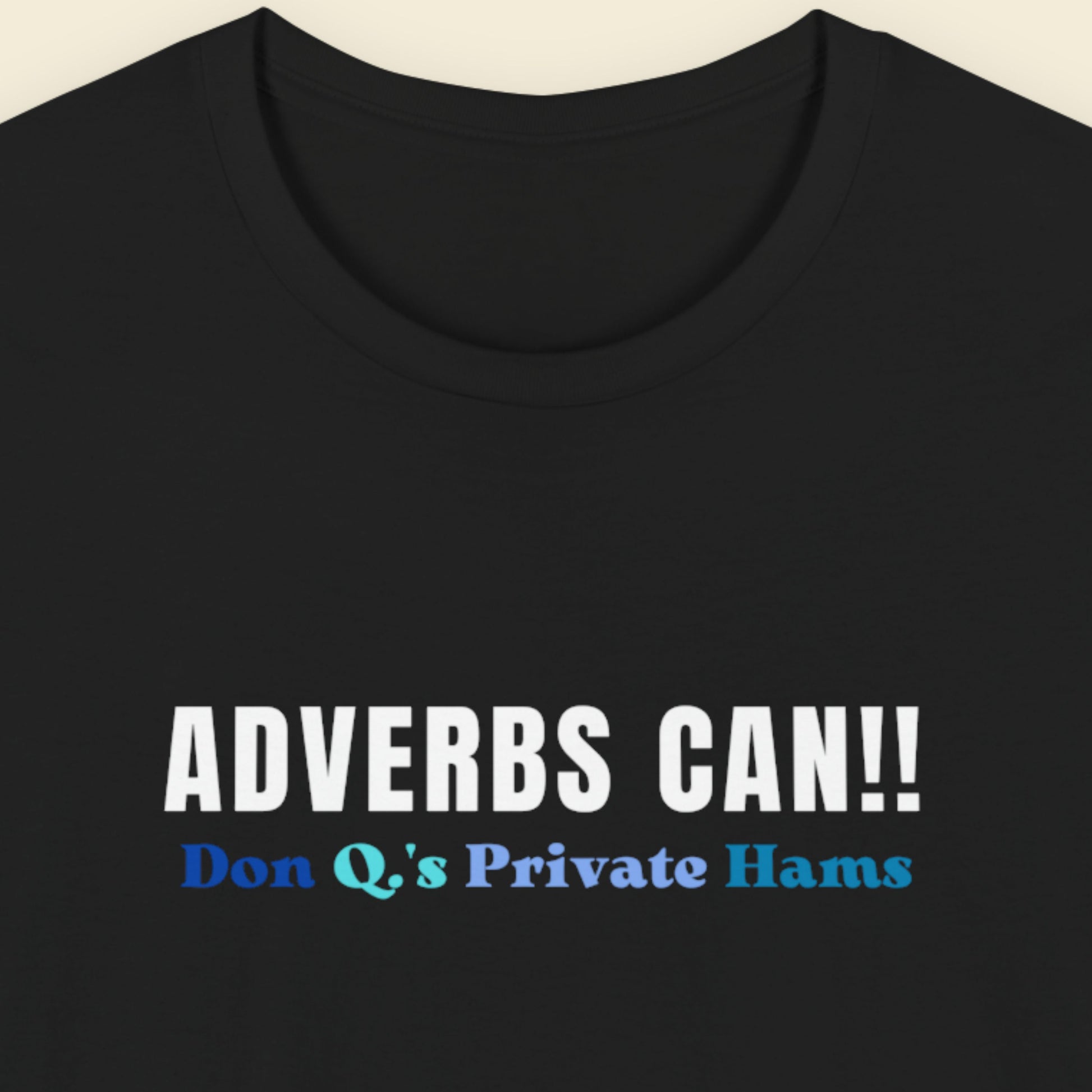 Black t-shirt with text 'ADVERBS CAN!! Don Q's Private Hams' on a beige background.