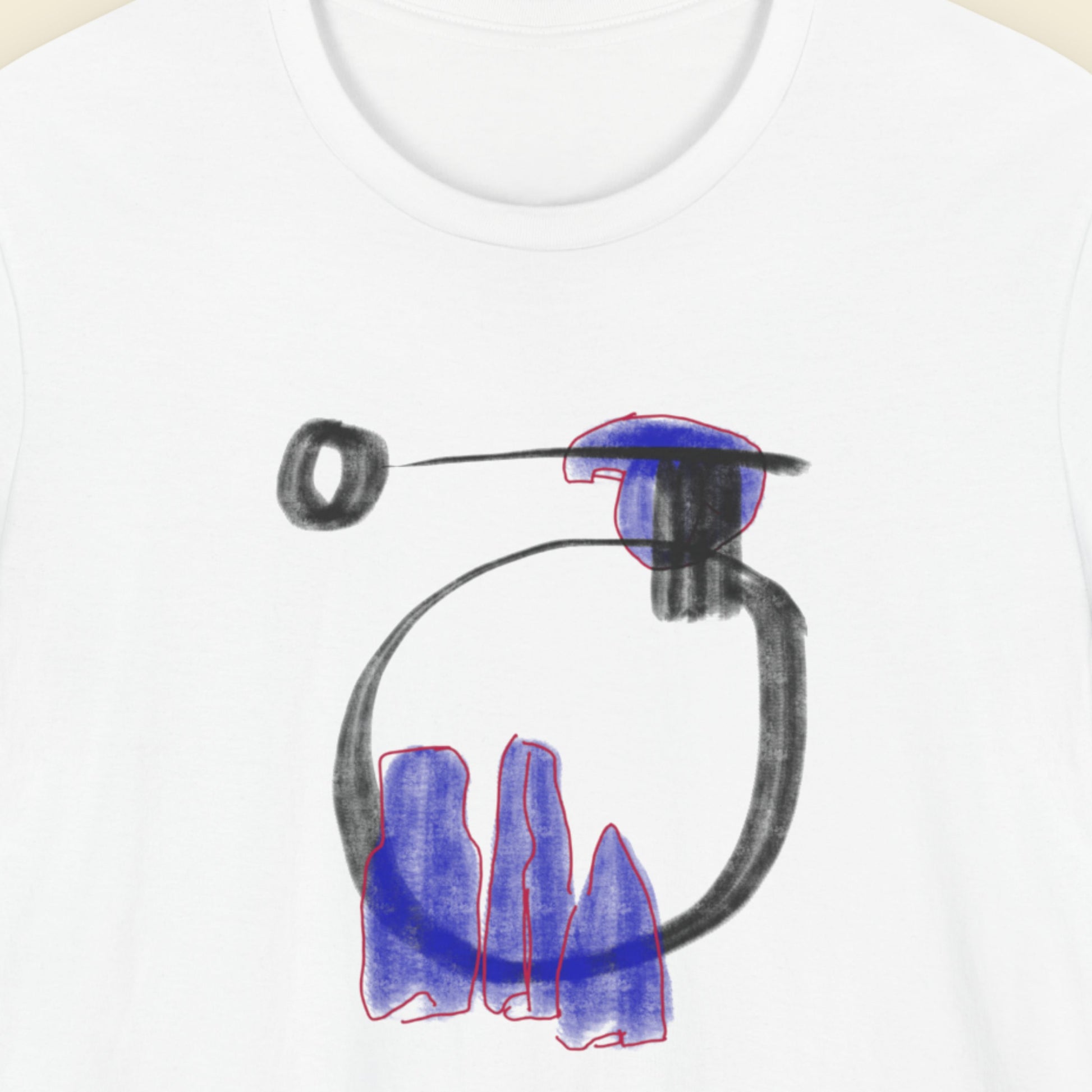 White t-shirt with a colorful abstract drawing on a beige background.