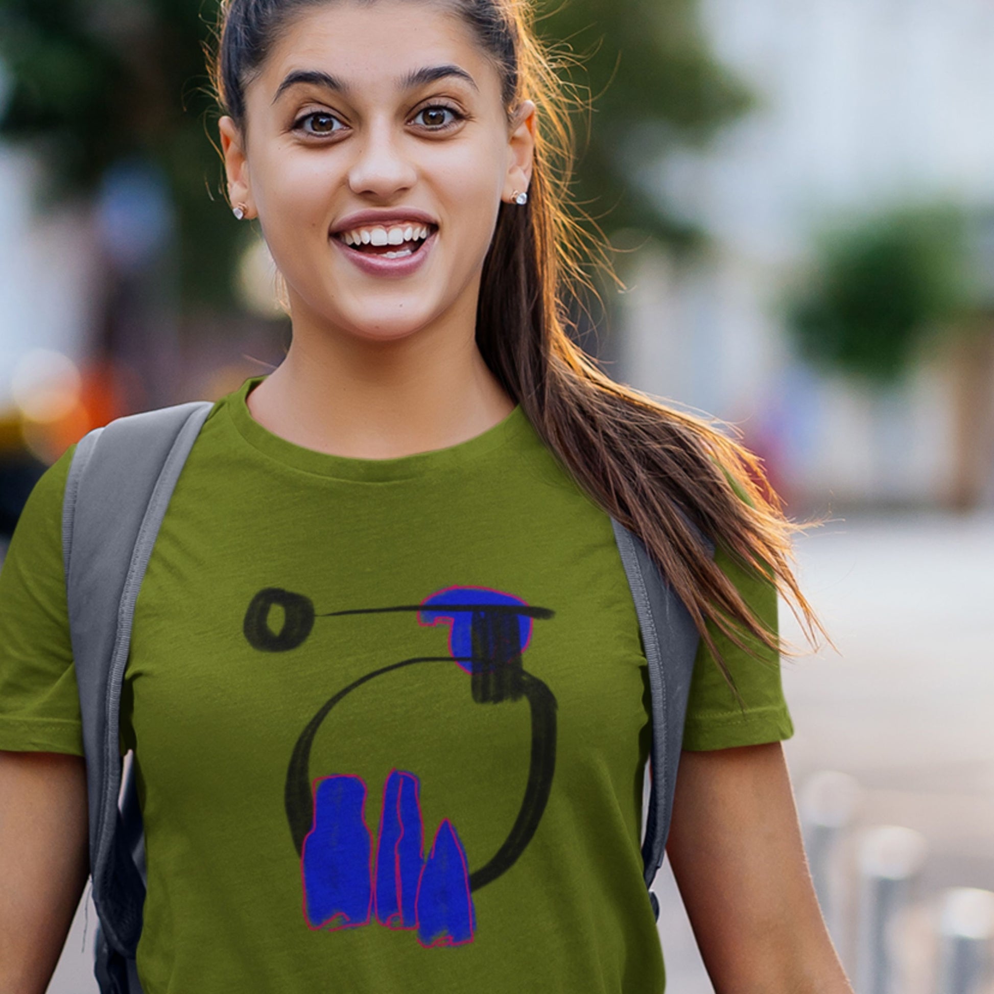 Woman wearing a green t-shirt with a colorful abstract drawing design.