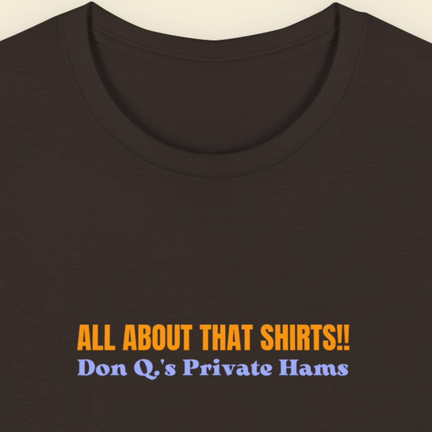 Brown t-shirt with multicolored 'all about that shirts!!' text on a beige background.