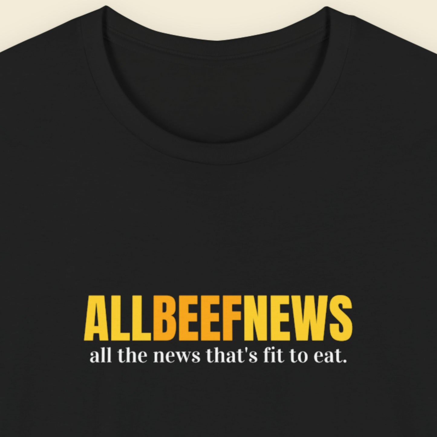 Black t-shirt with humorous colorful text on a beige background.