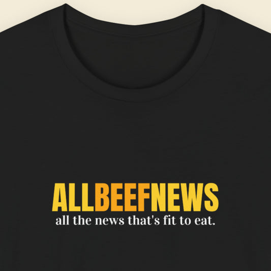 Black t-shirt with humorous colorful text on a beige background.