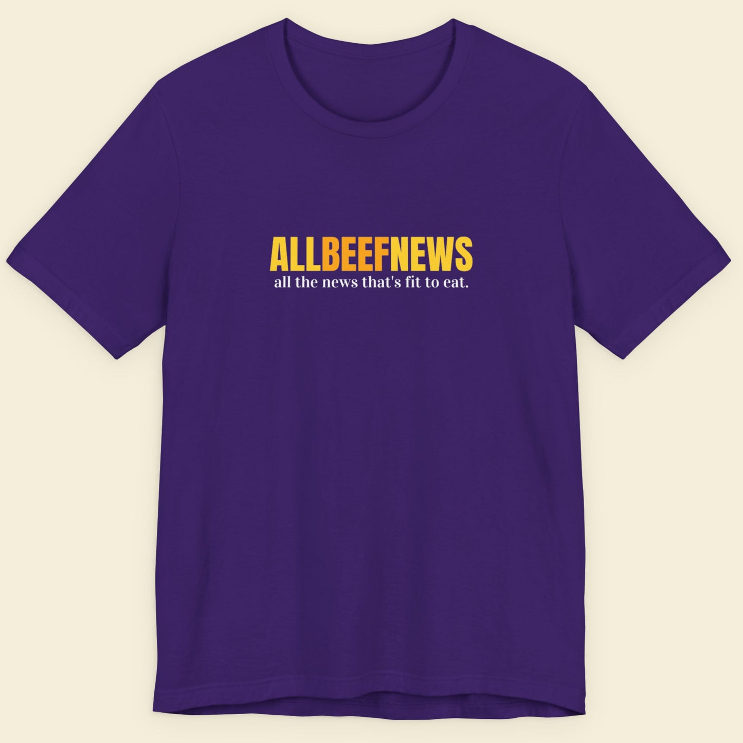 Purple t-shirt with humorous colorful text on a beige background.