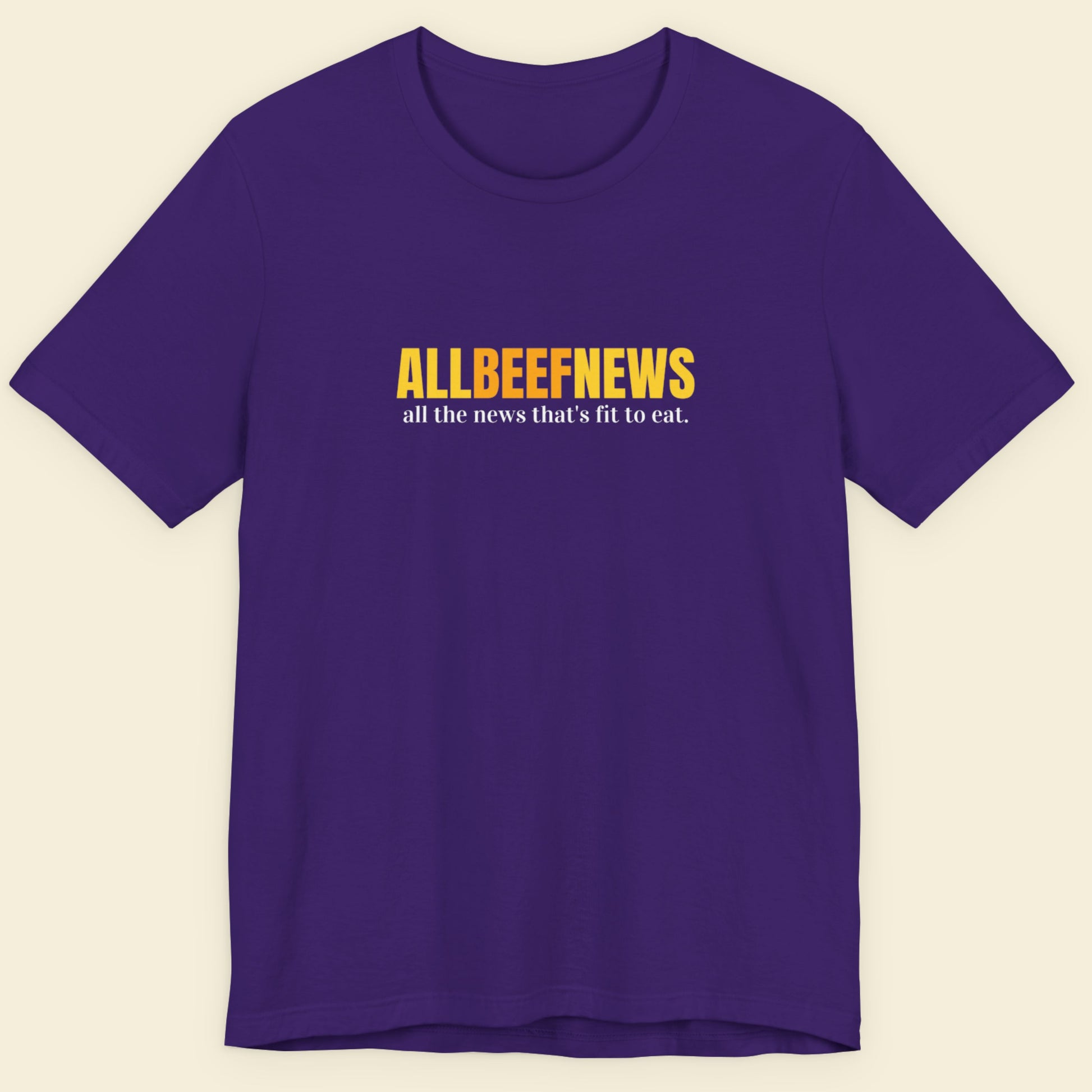 Purple t-shirt with humorous colorful text on a beige background.