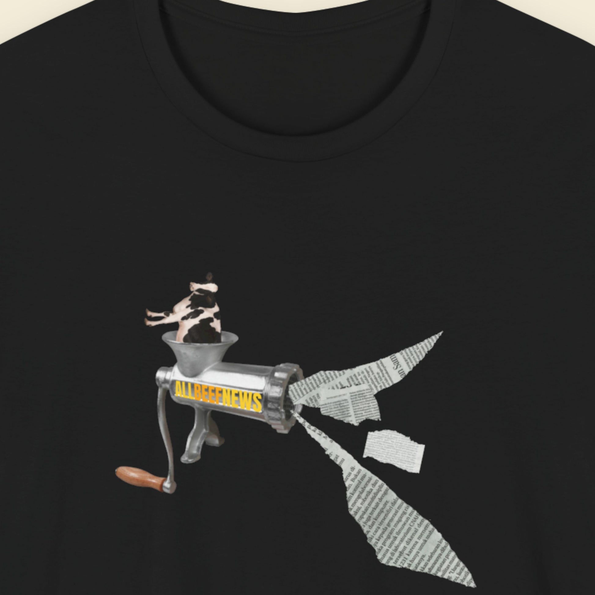 Black t-shirt with a fun, colorful cartoon illustration on a beige background.