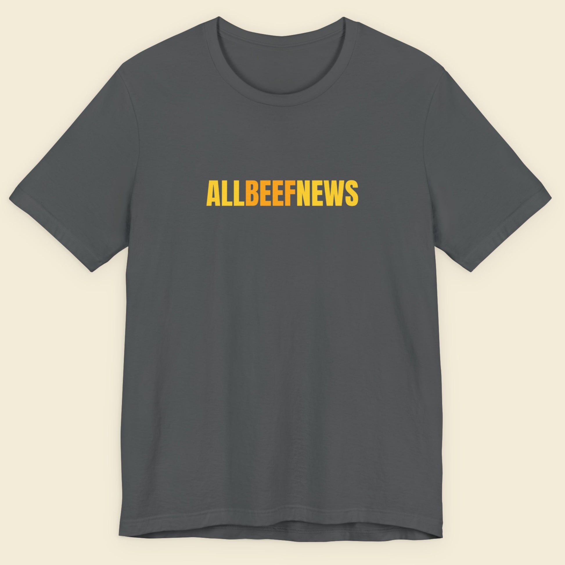 Grey t-shirt with humorous colorful ALLBEEFNEWS text on a beige background.