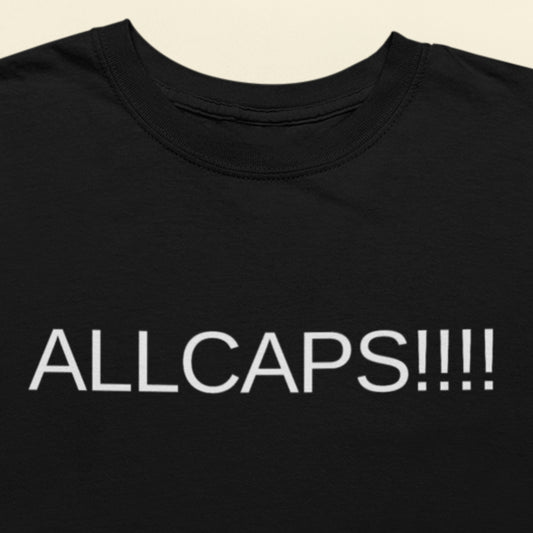 Black t-shirt with 'ALLCAPS!!!' text in white on a beige background