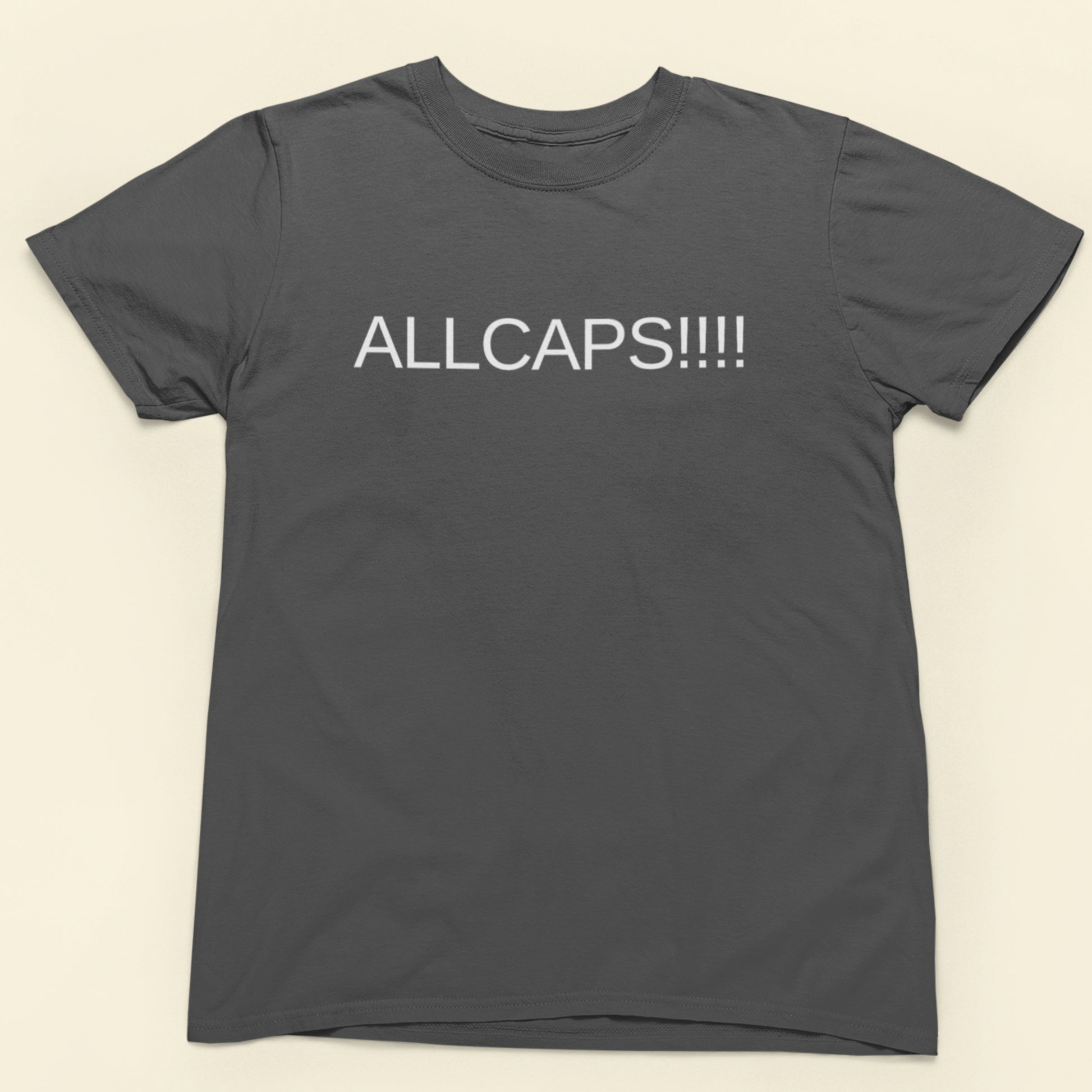 Gray t-shirt with 'ALLCAPS!!!!' text on a beige background