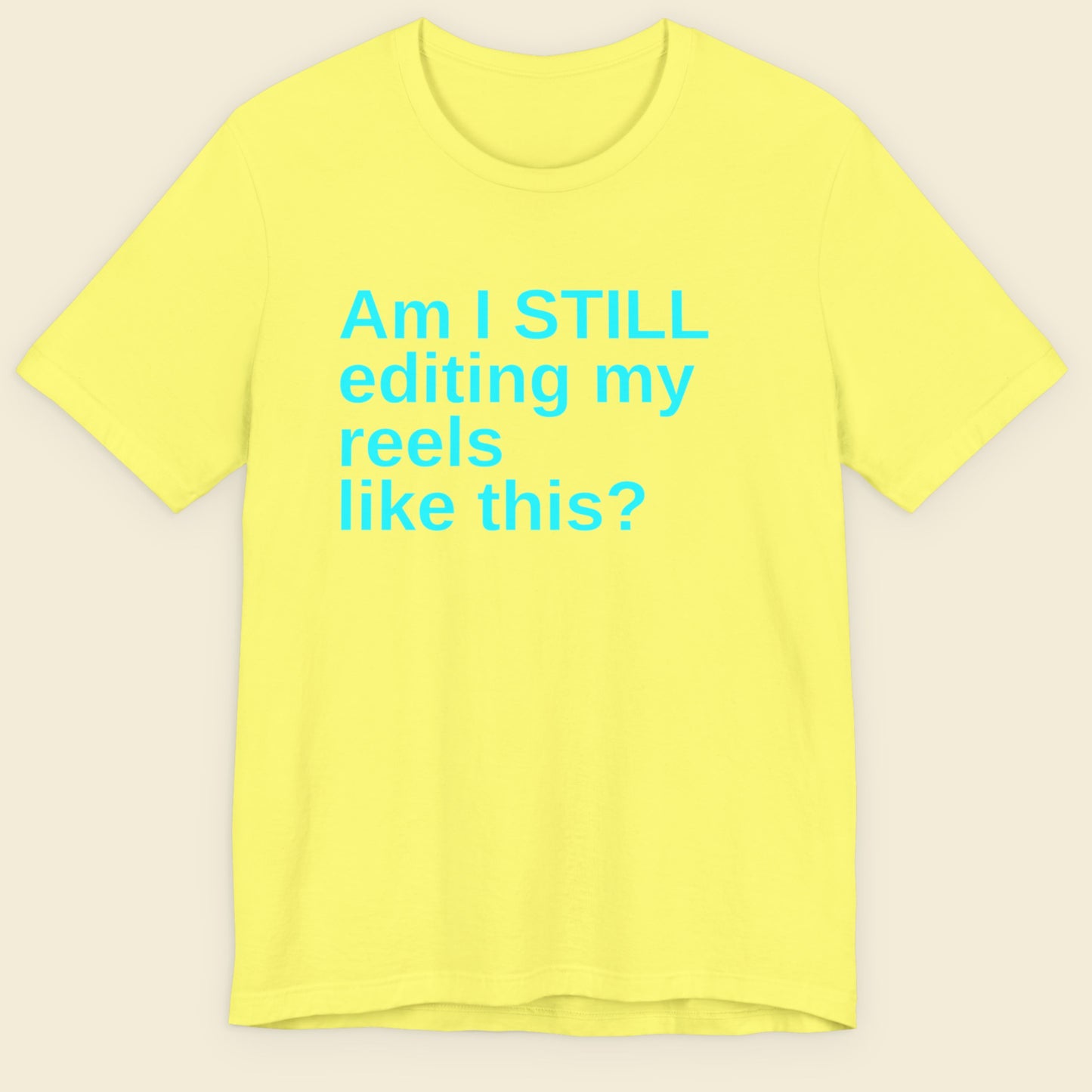 Yellow t-shirt with blue text on a beige background.