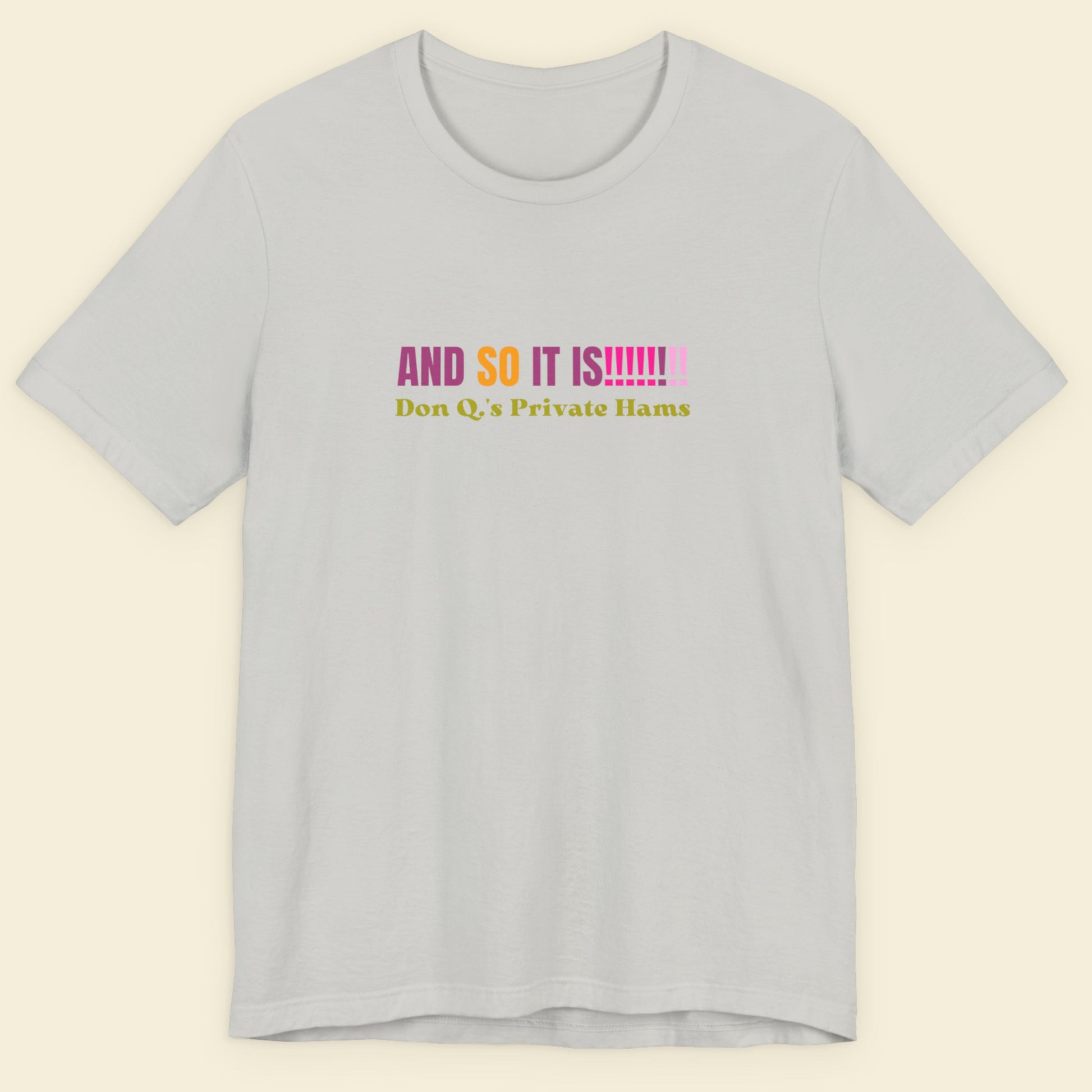 Grey t-shirt with multicolored 'and so it is!!!!!!!!' text on a beige background.